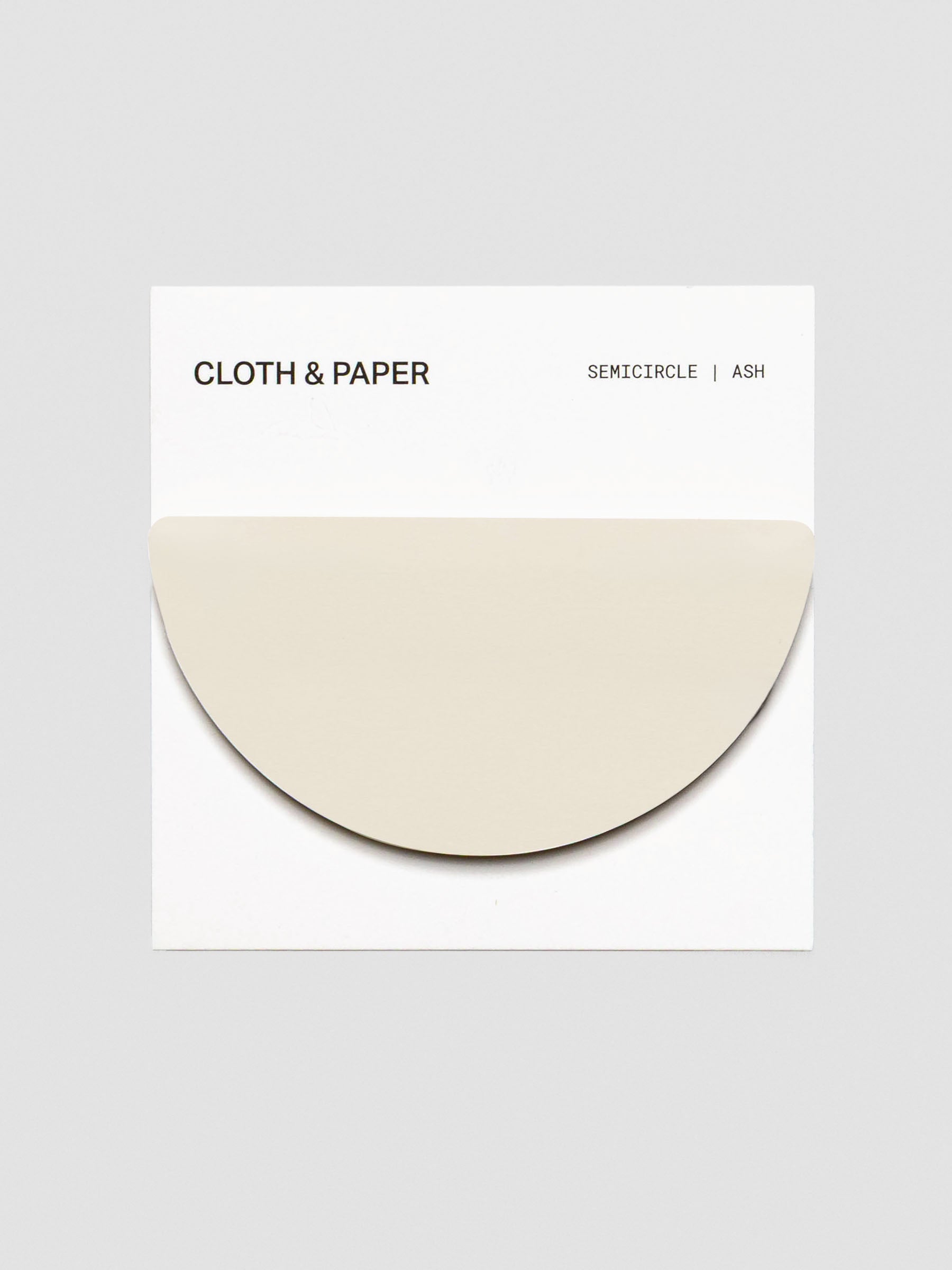 Cloth & Paper Semicircle Sticky Notes in Ash, shown on a branded backing card. A single pale beige half-circle pad is displayed against a white background.