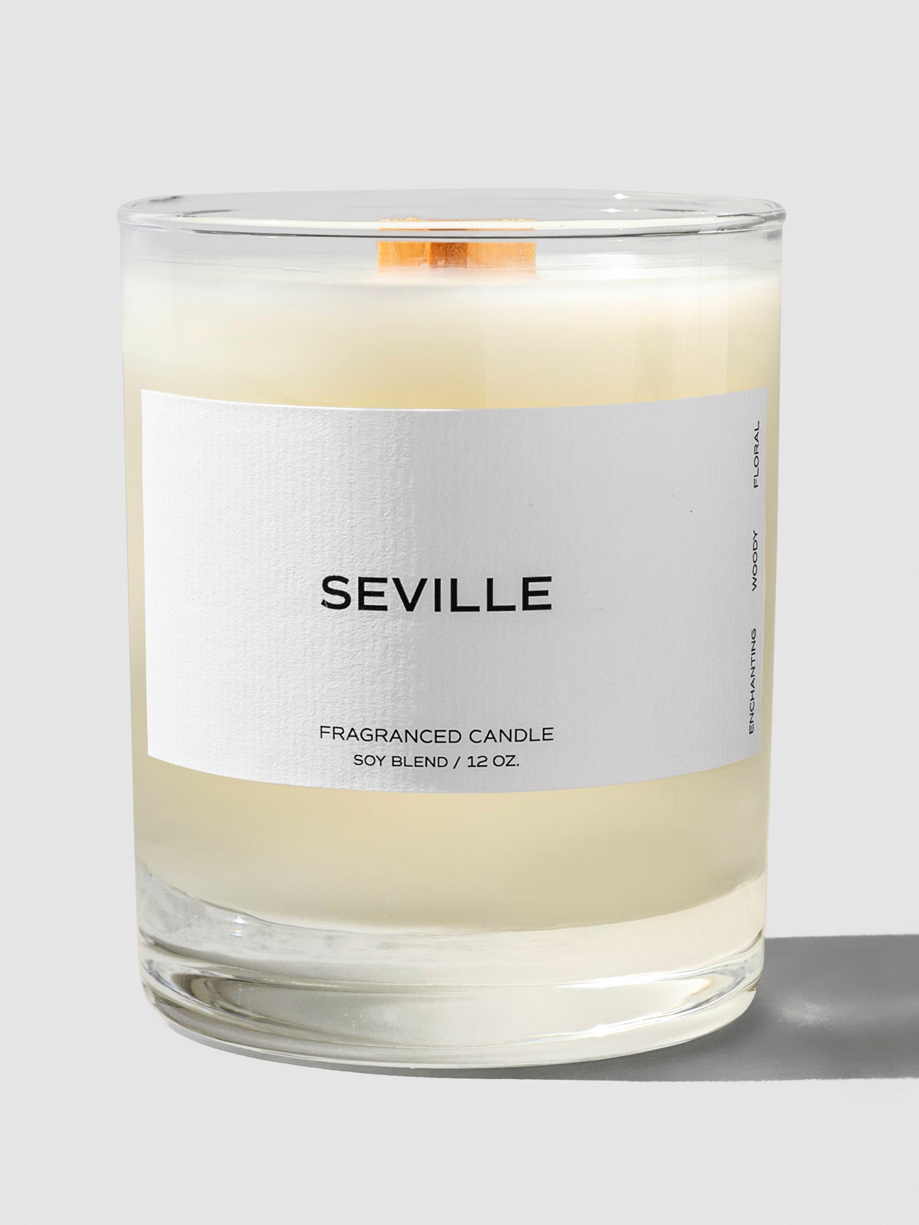 Seville Candle, Cloth and Paper. Candle displayed with its label facing the camera on a neutral background. Label reads "Seville" and the line below reads "Fragranced candle / Soy Blend / 12 oz"
