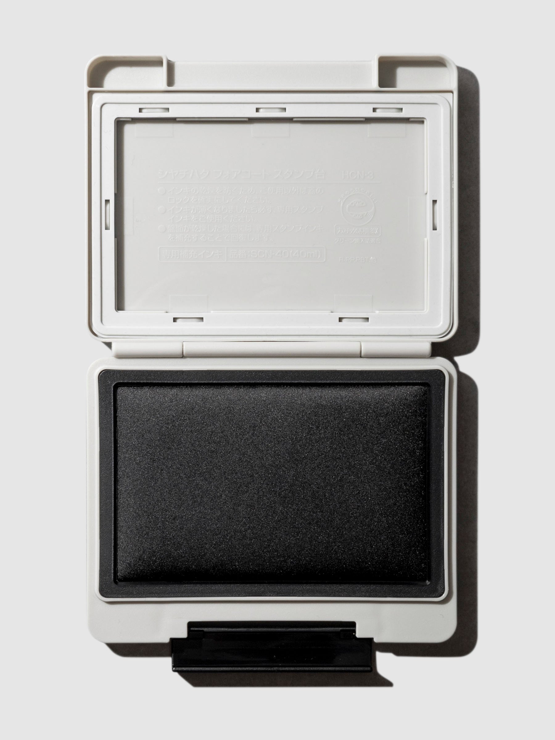 Shachihata Forecoat Stamp, Cloth and Paper. Stamp displayed open on a neutral background.