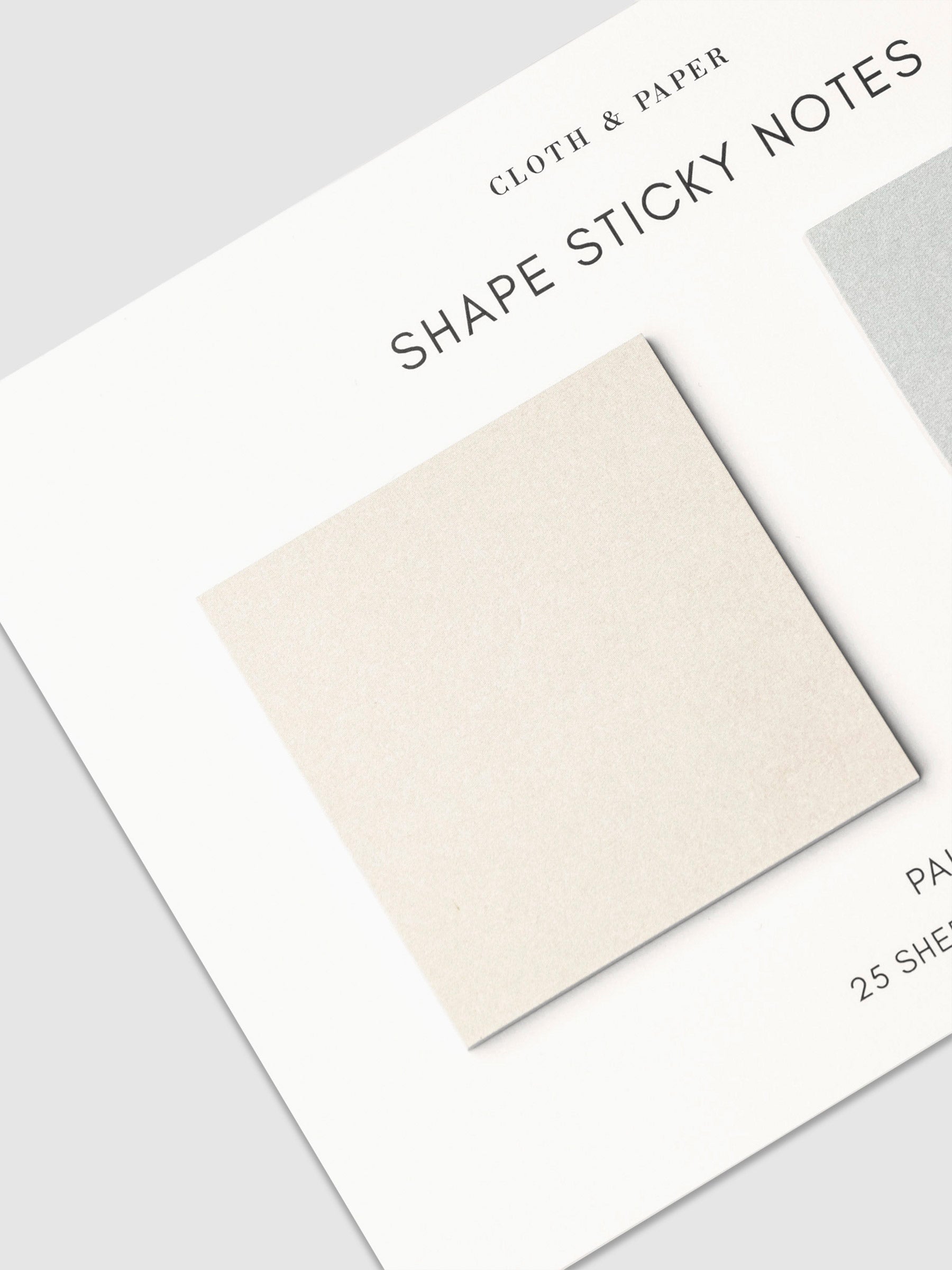 Close up on beige square sticky note on its backing.