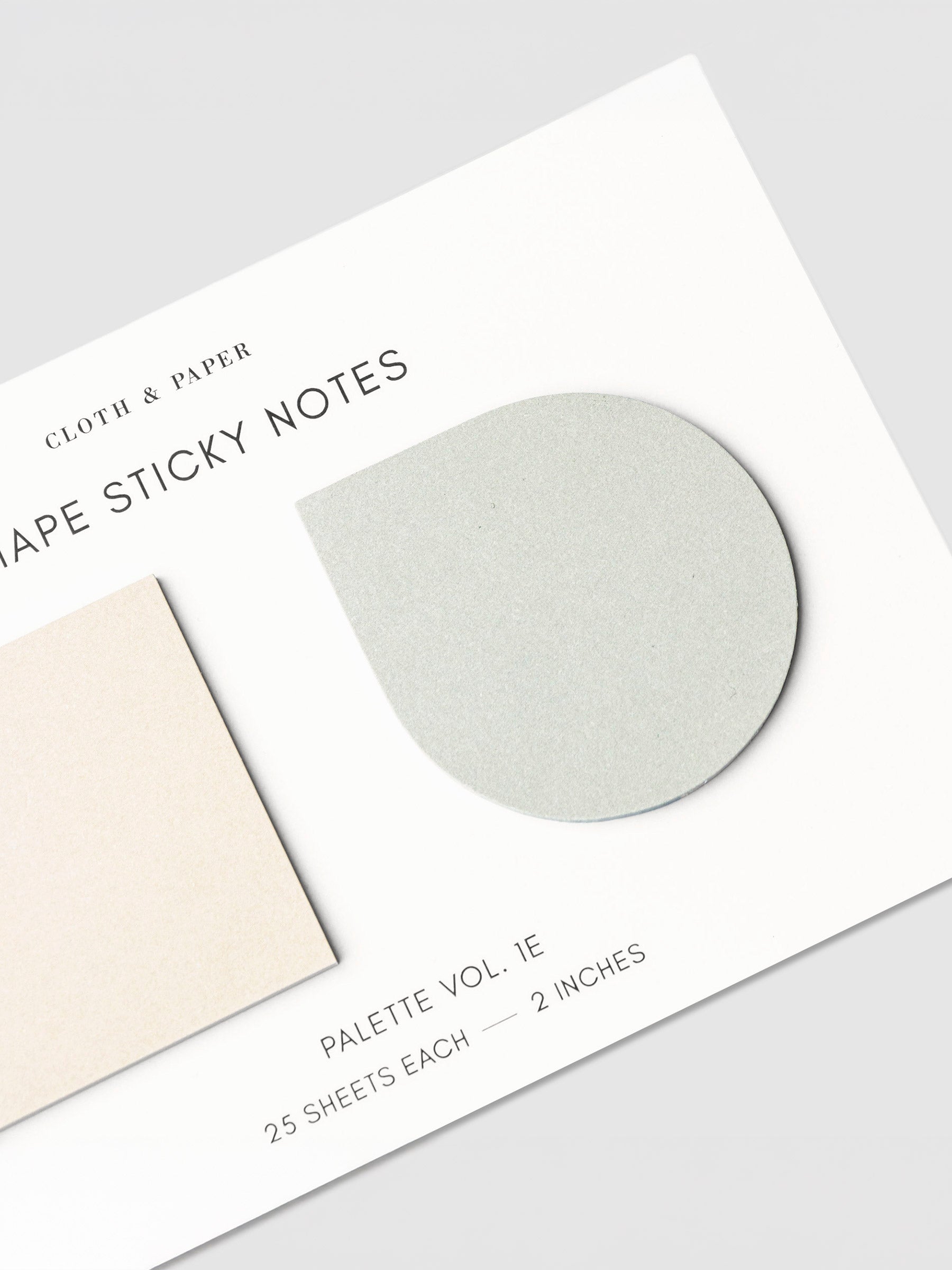 Close up on light green colored drop sticky note on its backing.