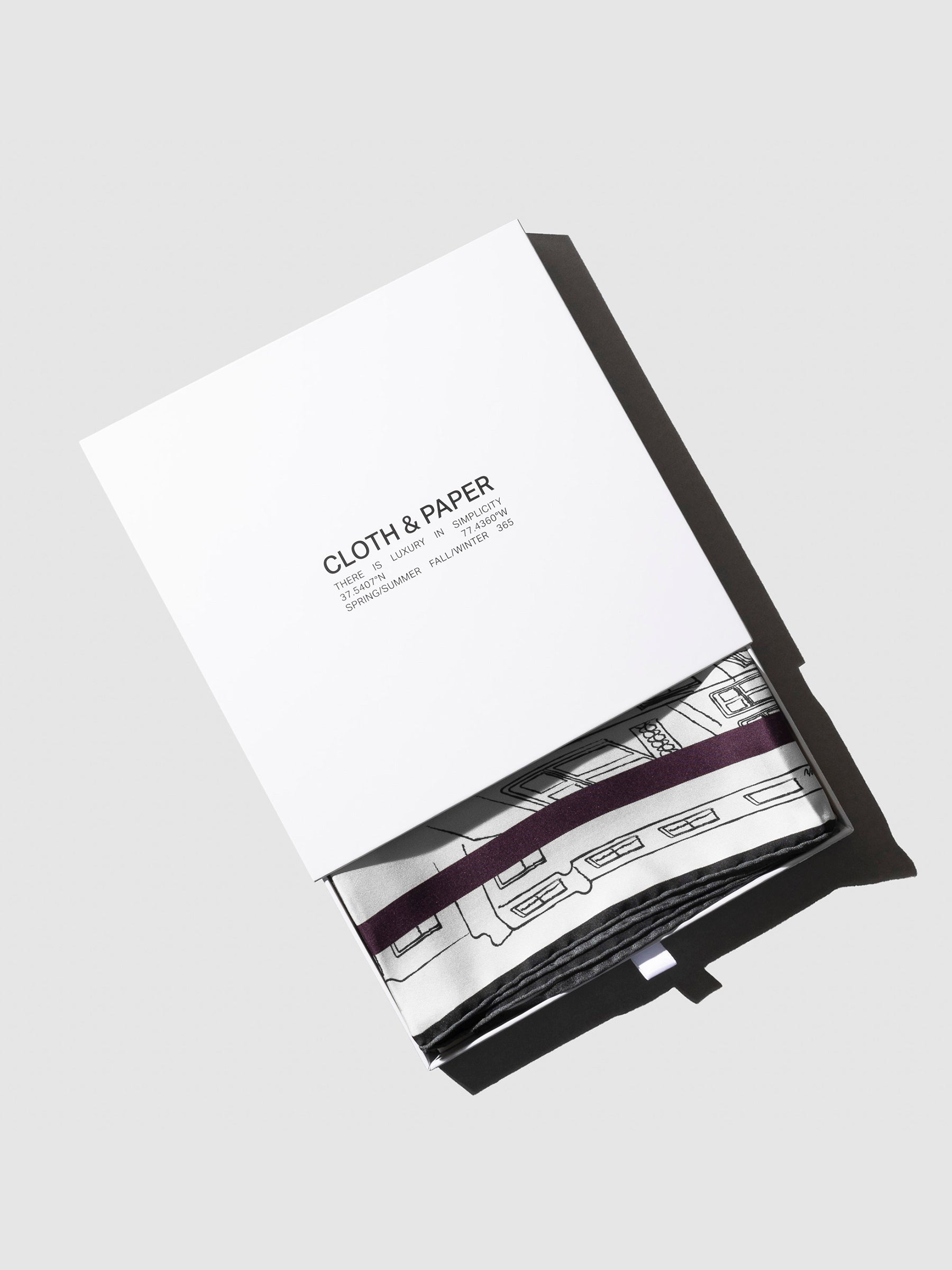 Scarf shown in its storage box, slightly exposed.