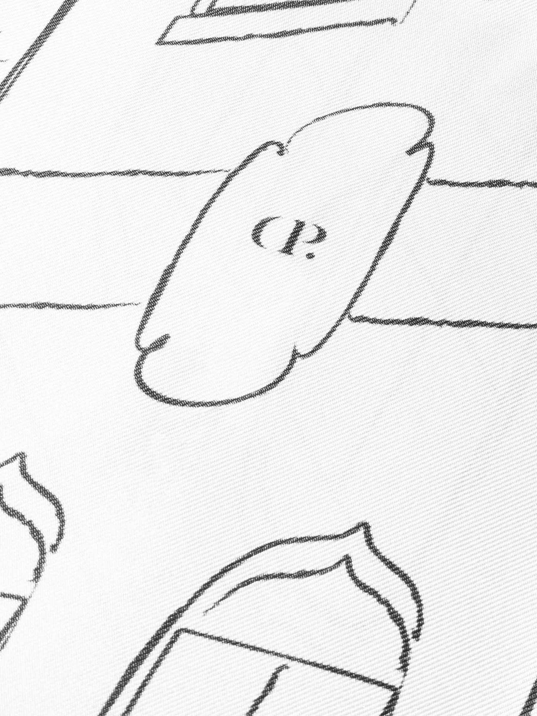 Closeup of printed design on scarf featuring architectural elements and the Cloth and Paper "CP" logo.