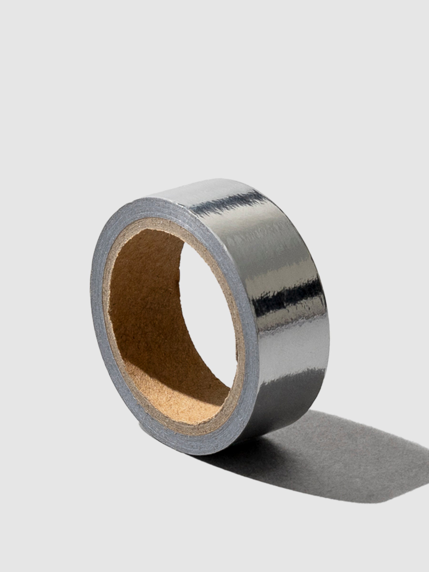 Silver Artisan Paper Tape, Cloth and Paper. Silver tape displayed on a neutral background.