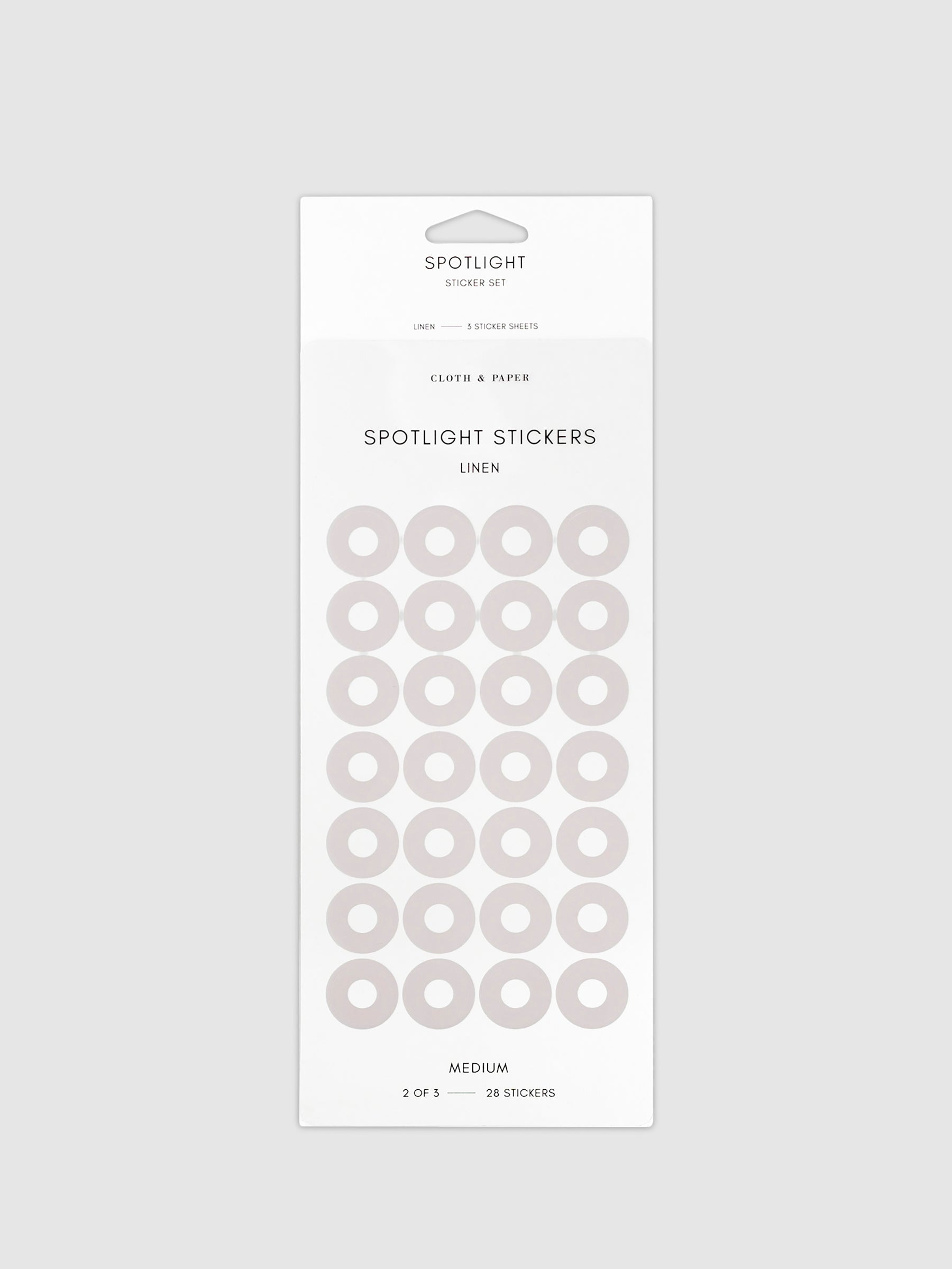 Medium sticker in its packaging displayed on a neutral background. Pictured color is linen.