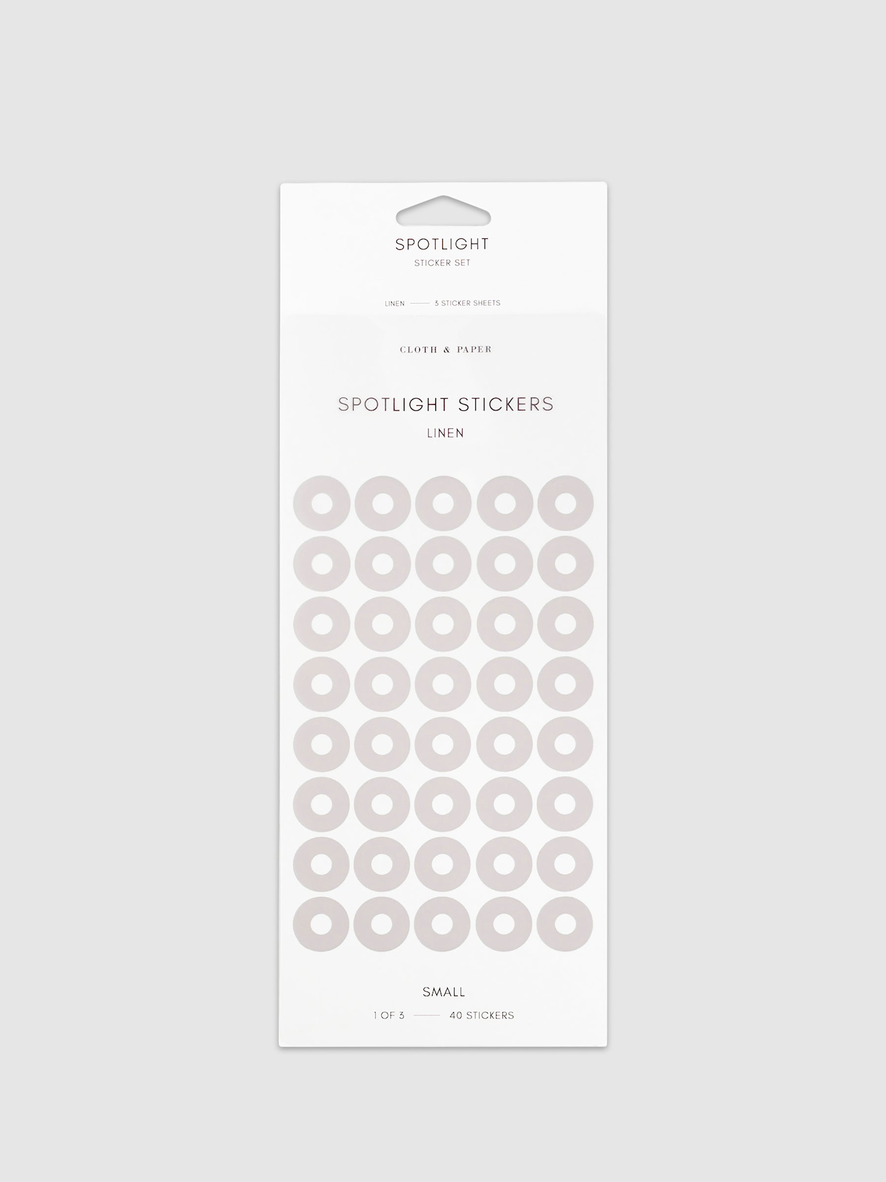 Small sticker in its packaging displayed on a neutral background. Pictured color is linen.