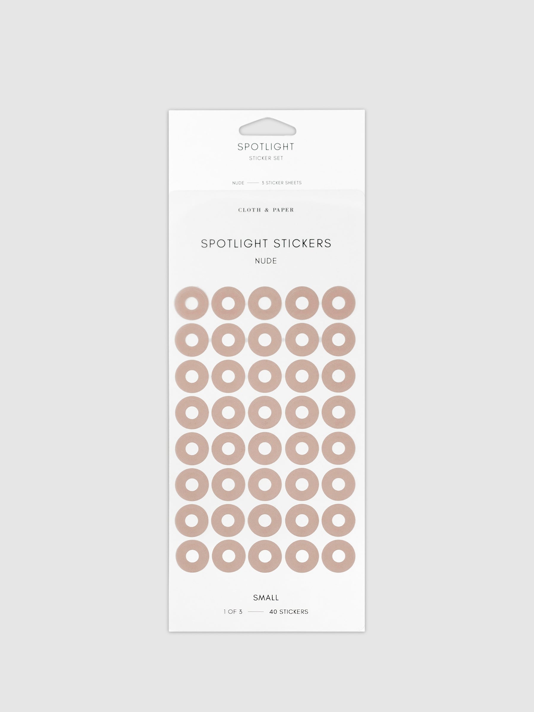 Small sticker in its packaging displayed on a neutral background. Pictured color is nude.