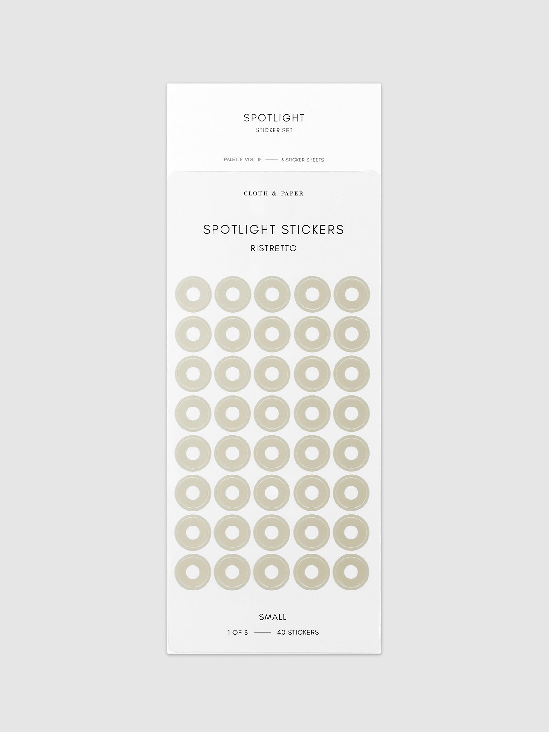 Small sticker in its packaging displayed on a neutral background. Pictured color is ristretto.