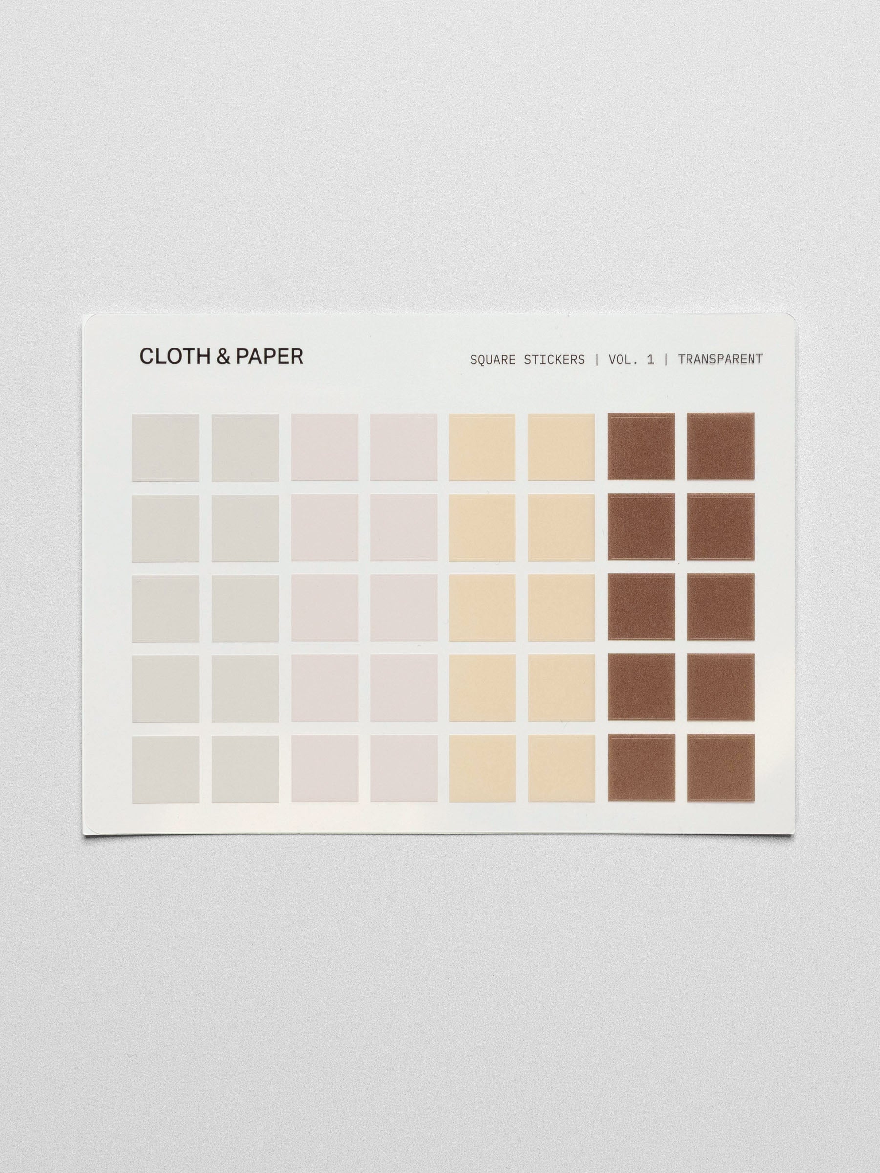 A close-up of a single Square Stickers Vol. 1 sheet showing pastel and warm neutral tones arranged in a grid pattern.