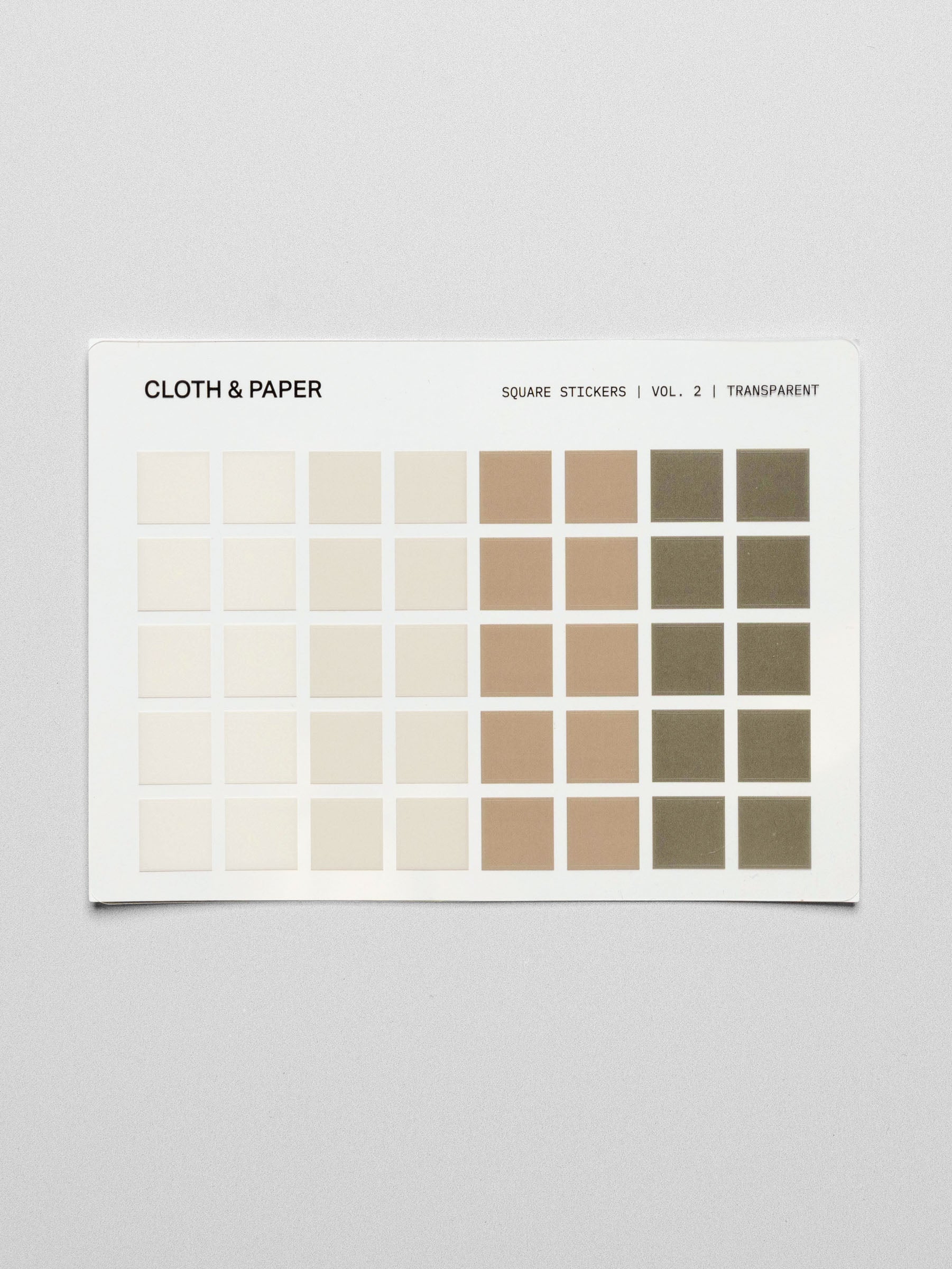 A single sheet of Square Stickers Vol. 2 with varying shades of beige, tan, and olive green squares on a transparent sheet.