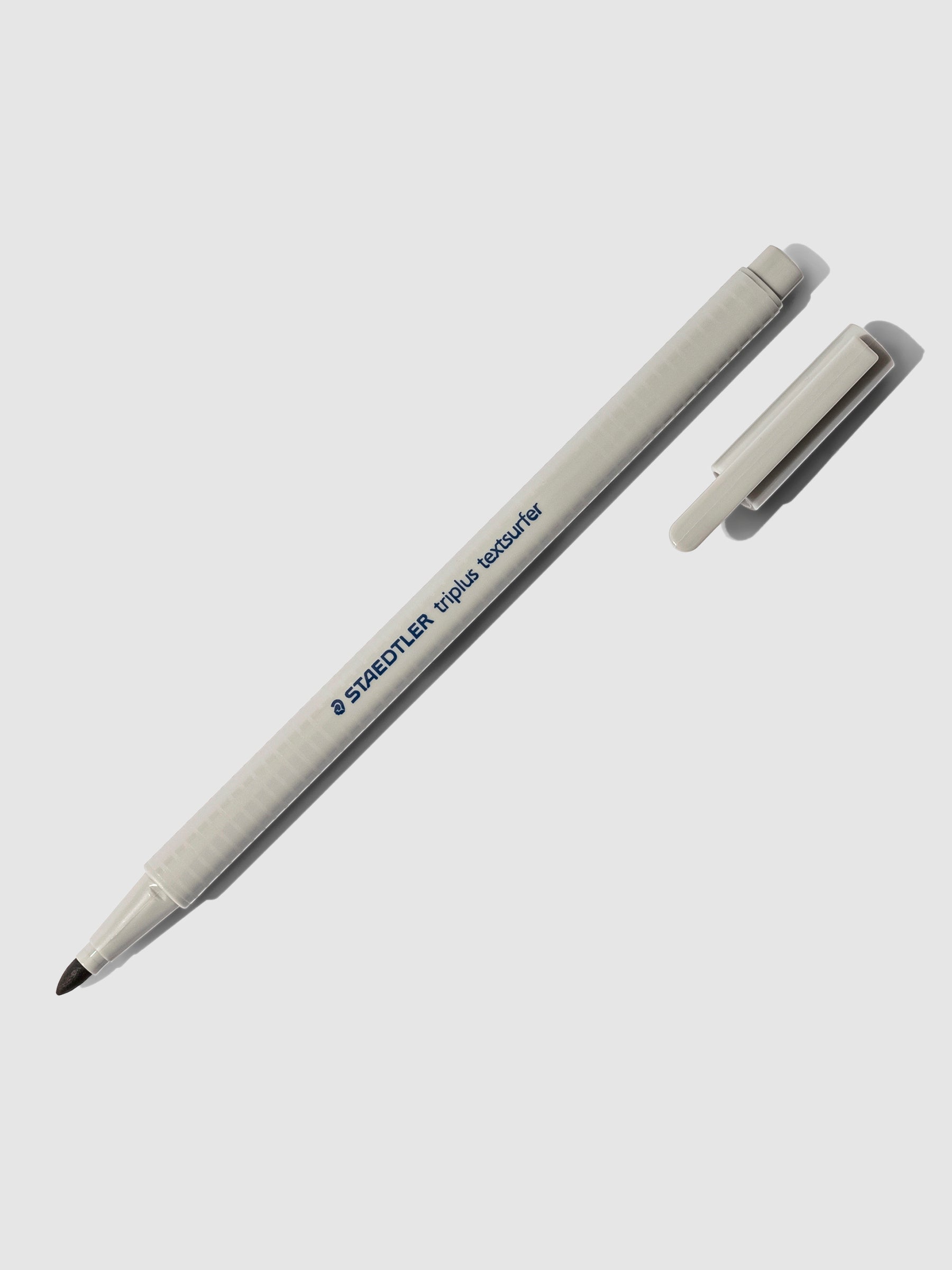 Staedtler Triplus Textsurfer Highlighter, Cloth and Paper. Highlighter shown uncapped on a neutral background. Color shown is grey.