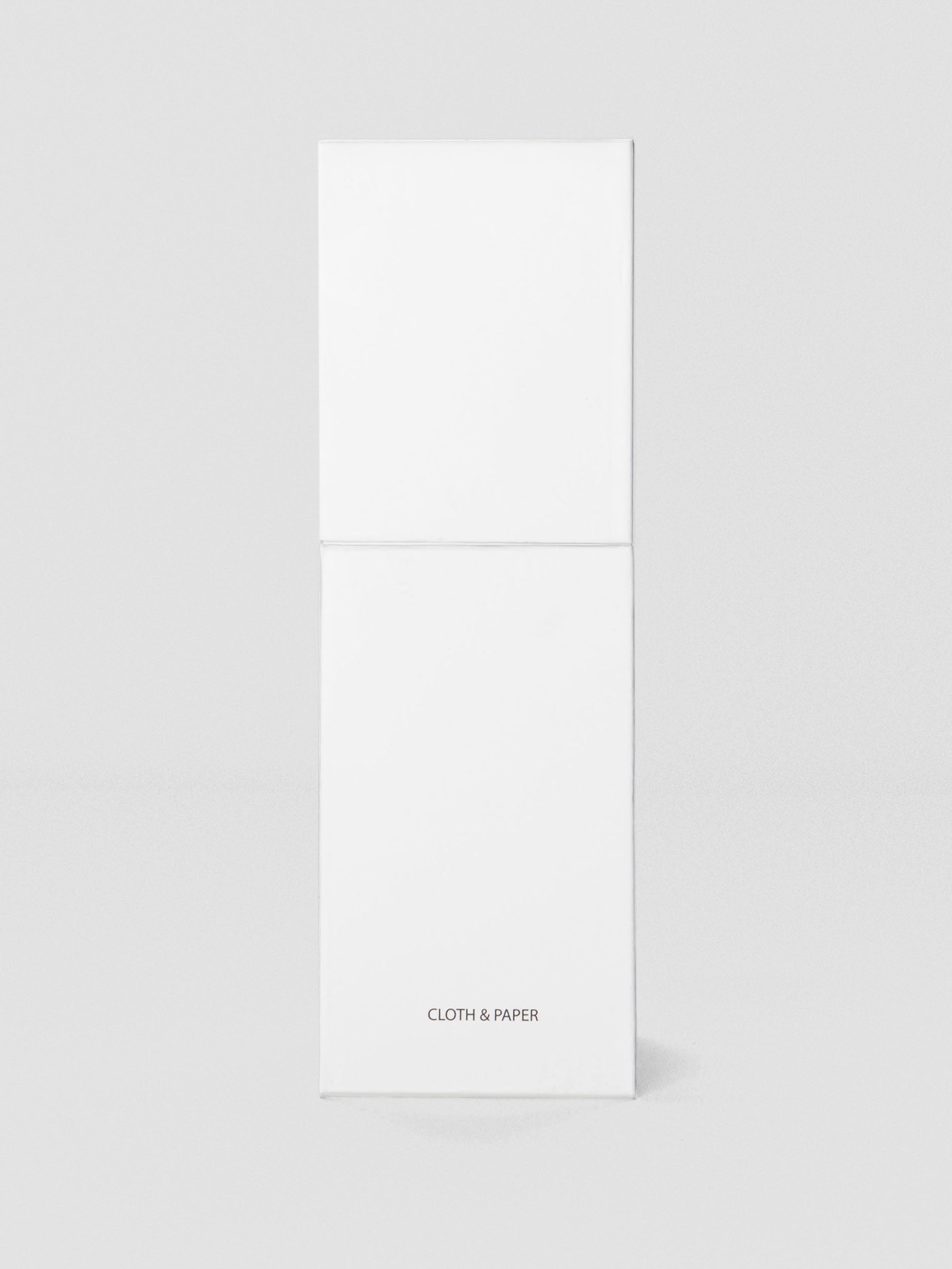 Tall white box with minimal design, featuring the Cloth & Paper logo near the base.