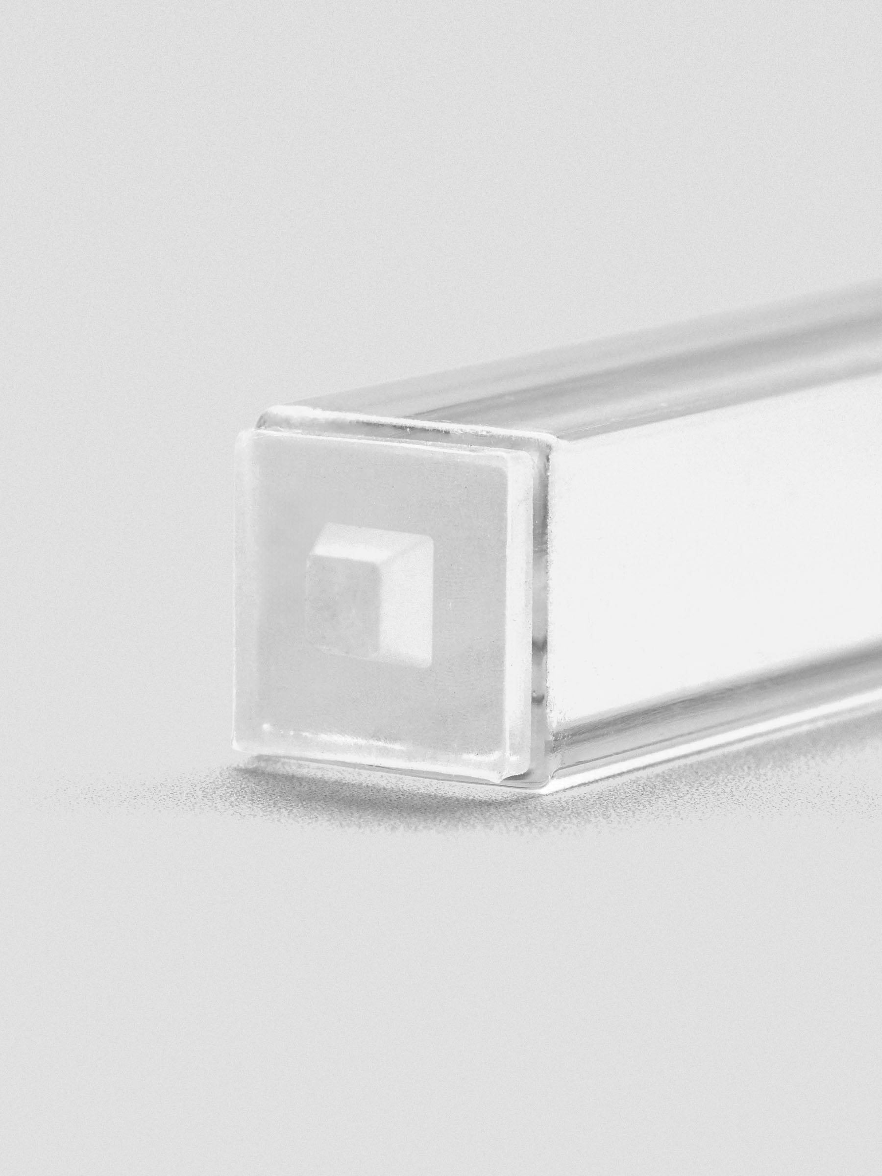 Close-up of stamp stick end with an engraved filled square icon.