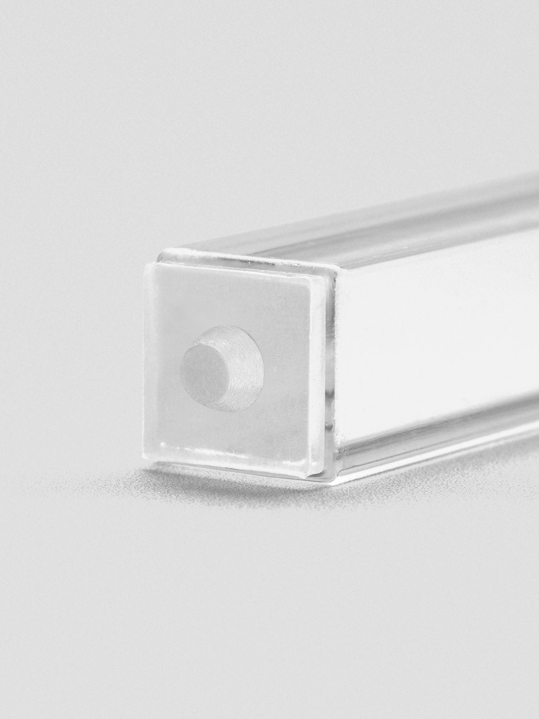 Close-up of stamp stick end with an engraved filled circle icon.