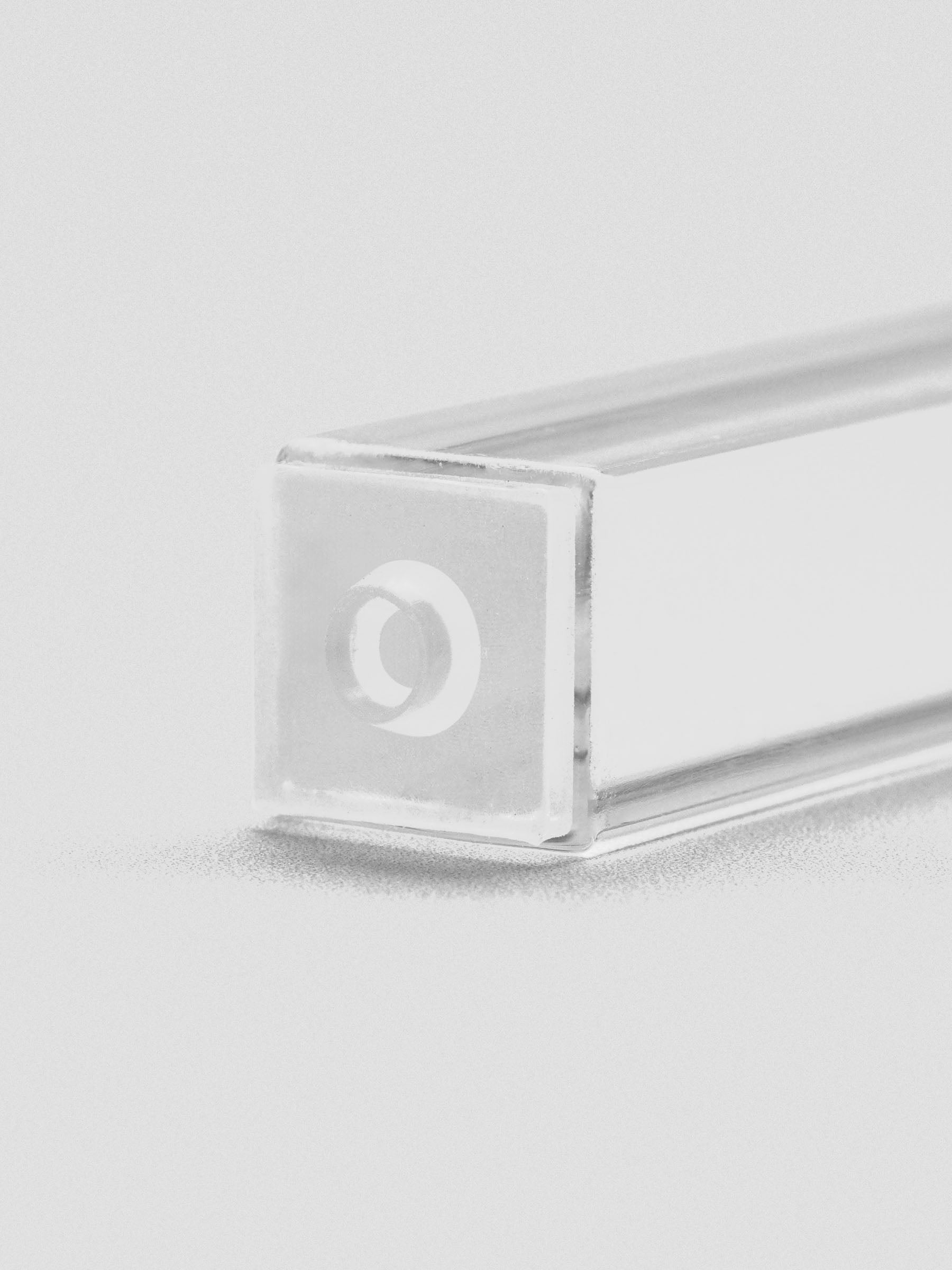 Close-up of stamp stick end with an engraved outlined circle icon.