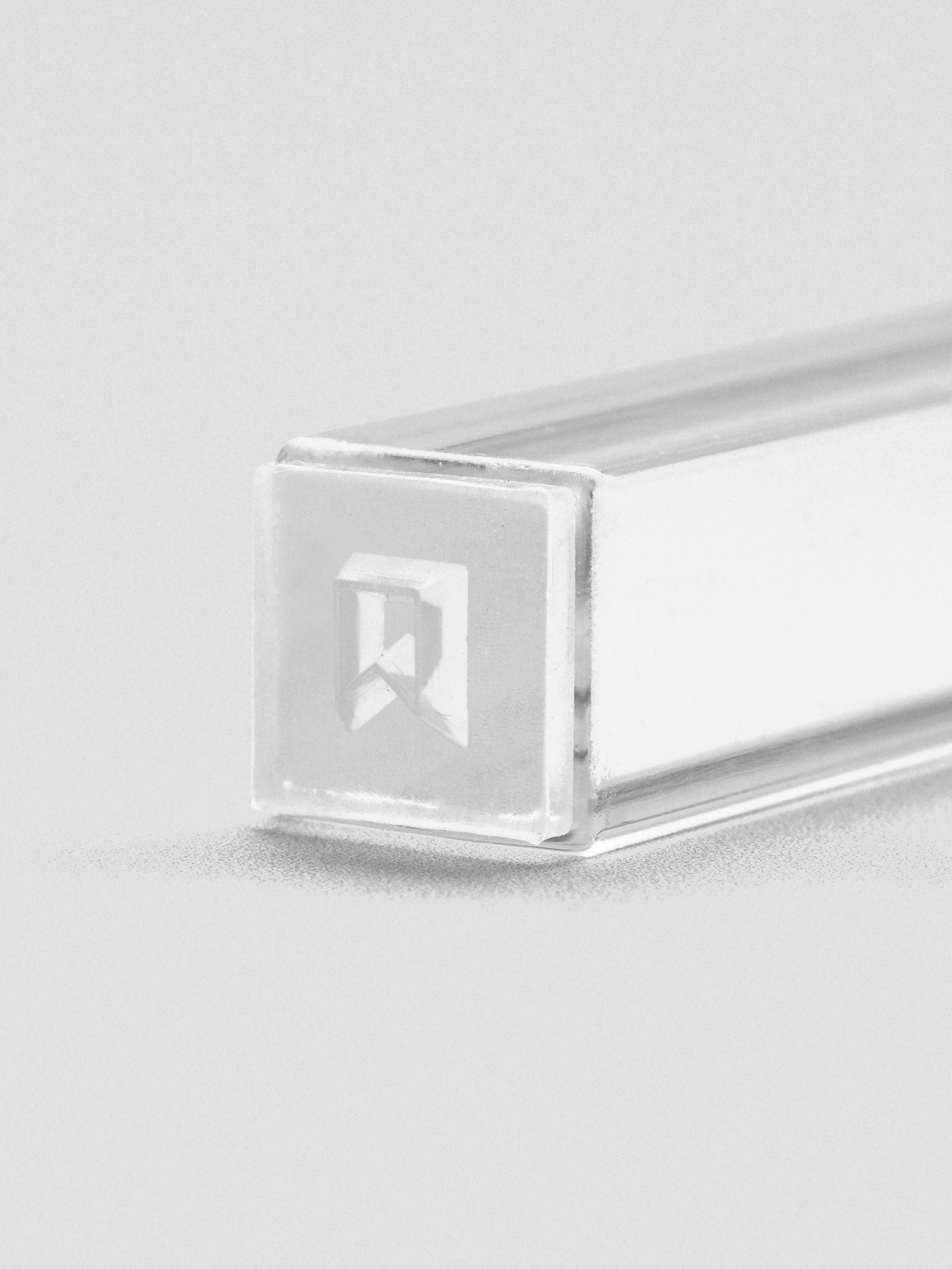 Close-up of stamp stick end with an engraved flag icon.
