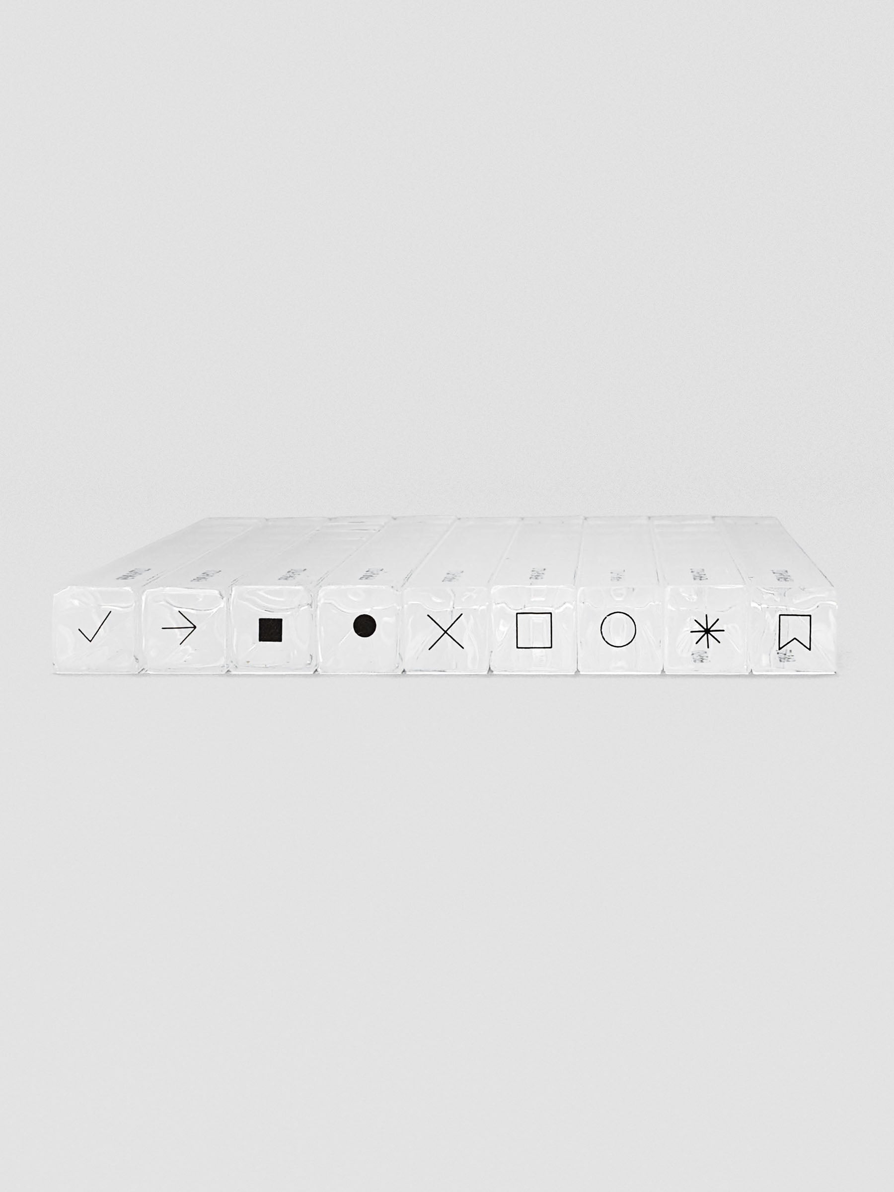 Nine stamp sticks lined up side-by-side with black icons on top, showing different shapes and symbols.