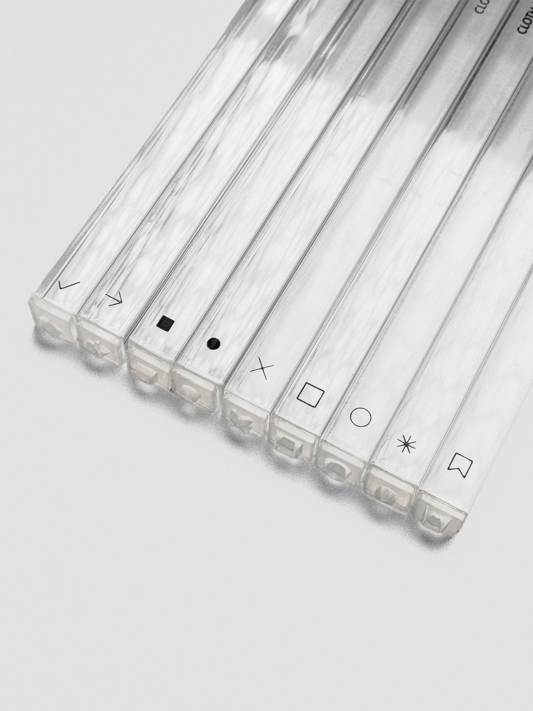 Angled view of stamp sticks lying flat, icons facing forward, showcasing the clear acrylic sides.