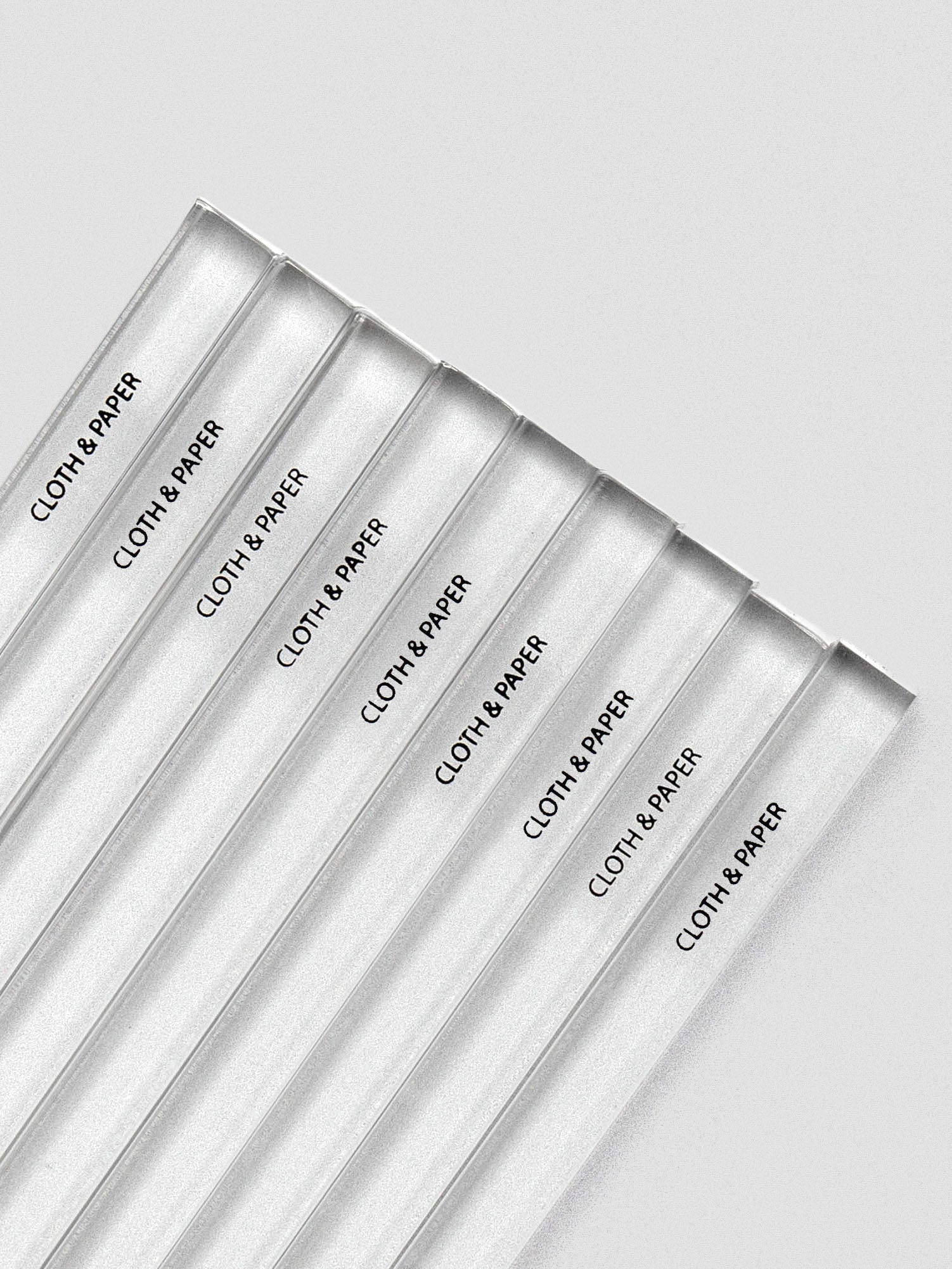 Close-up of stamp stick sides, each printed with the Cloth & Paper logo in black.