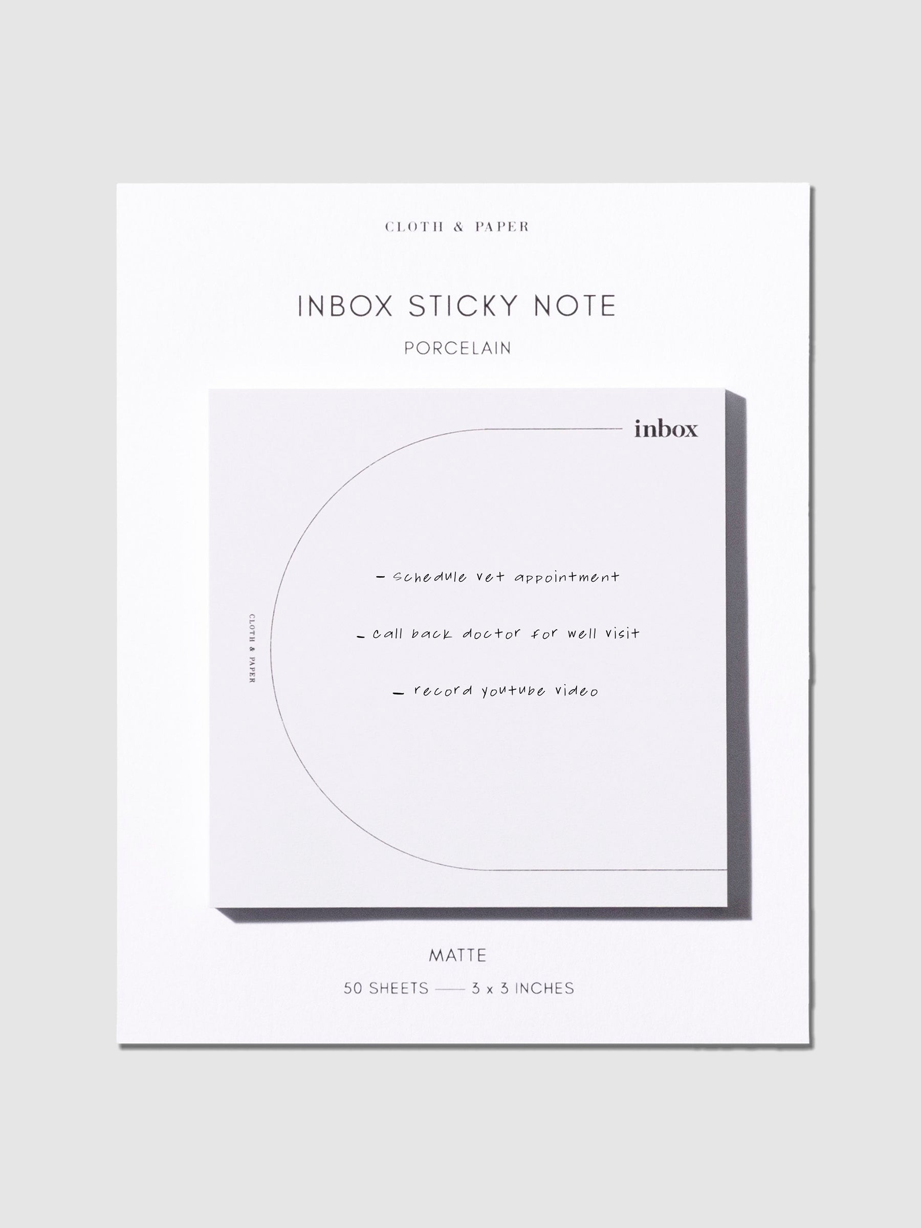 Sticky notes on their backing against a neutral background. An example to do list is written on the sticky note.