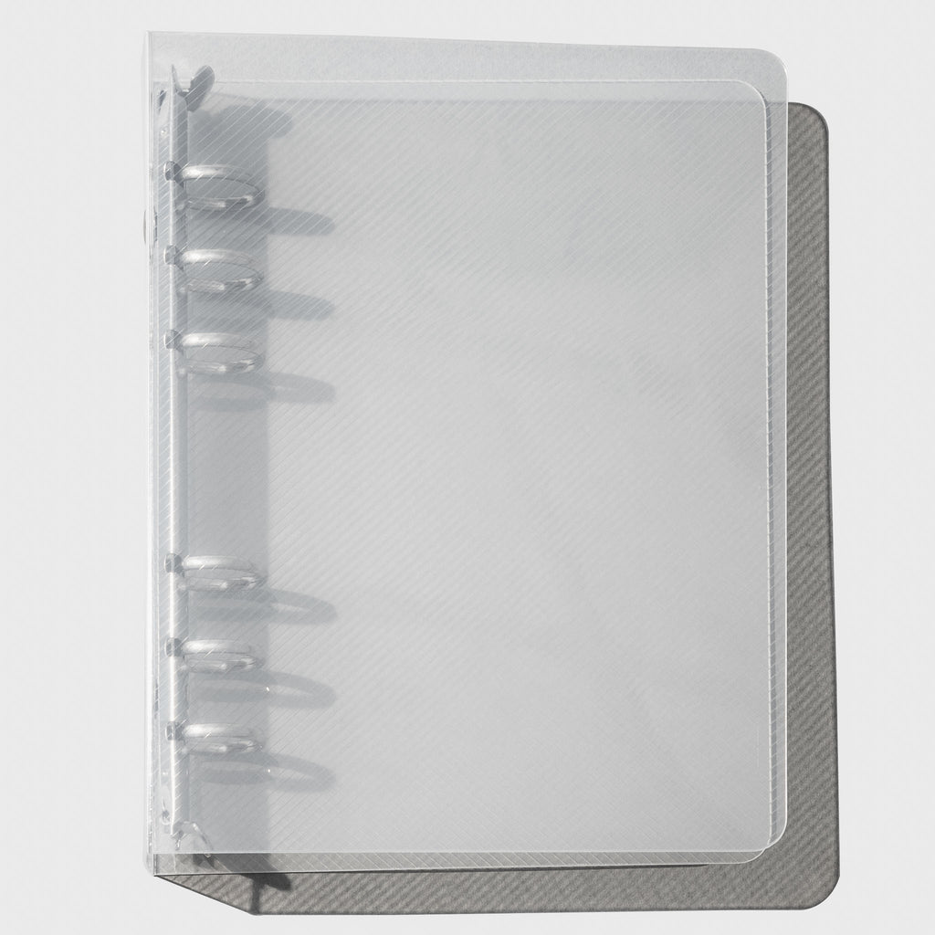 Textured Plastic Binder, Personal, Cloth & Paper. Closed transparent binder on a white background.