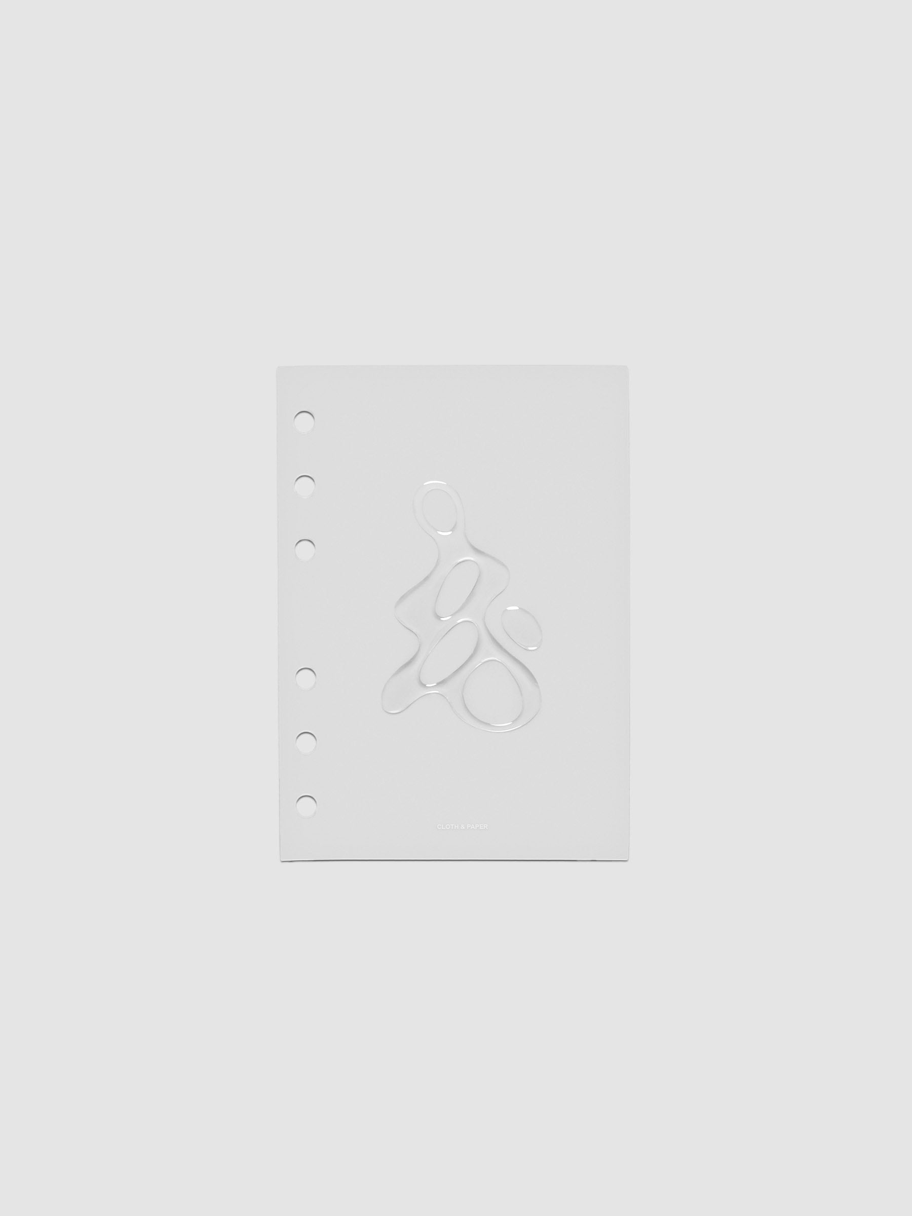 Light grey, semi-transparent, and glossy plastic planner dashboard with organic raised shape design in size A6 on a neutral background.