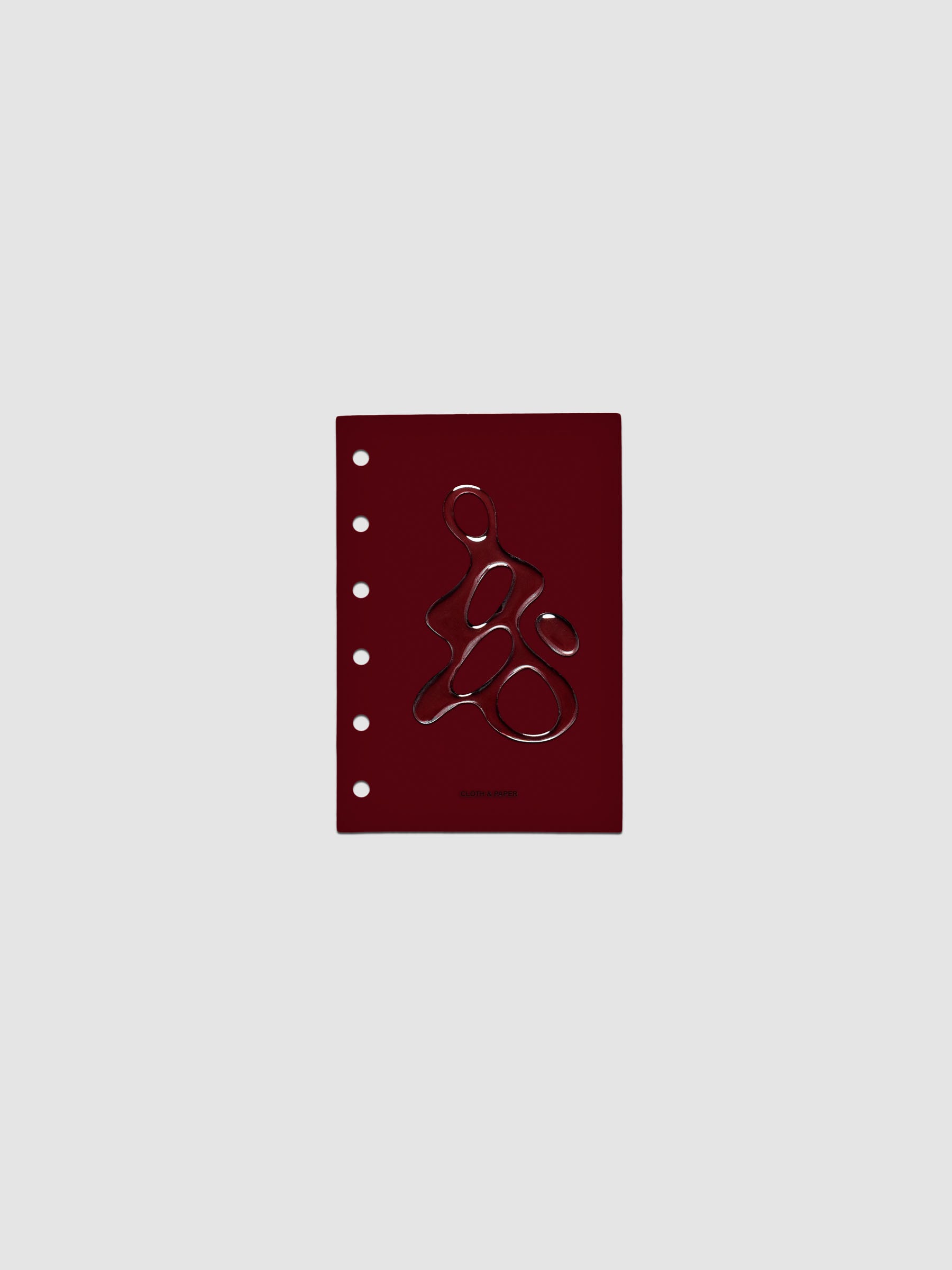 Dark red, semi-transparent, and glossy plastic planner dashboard with organic raised shape design in size Pocket on a neutral background.