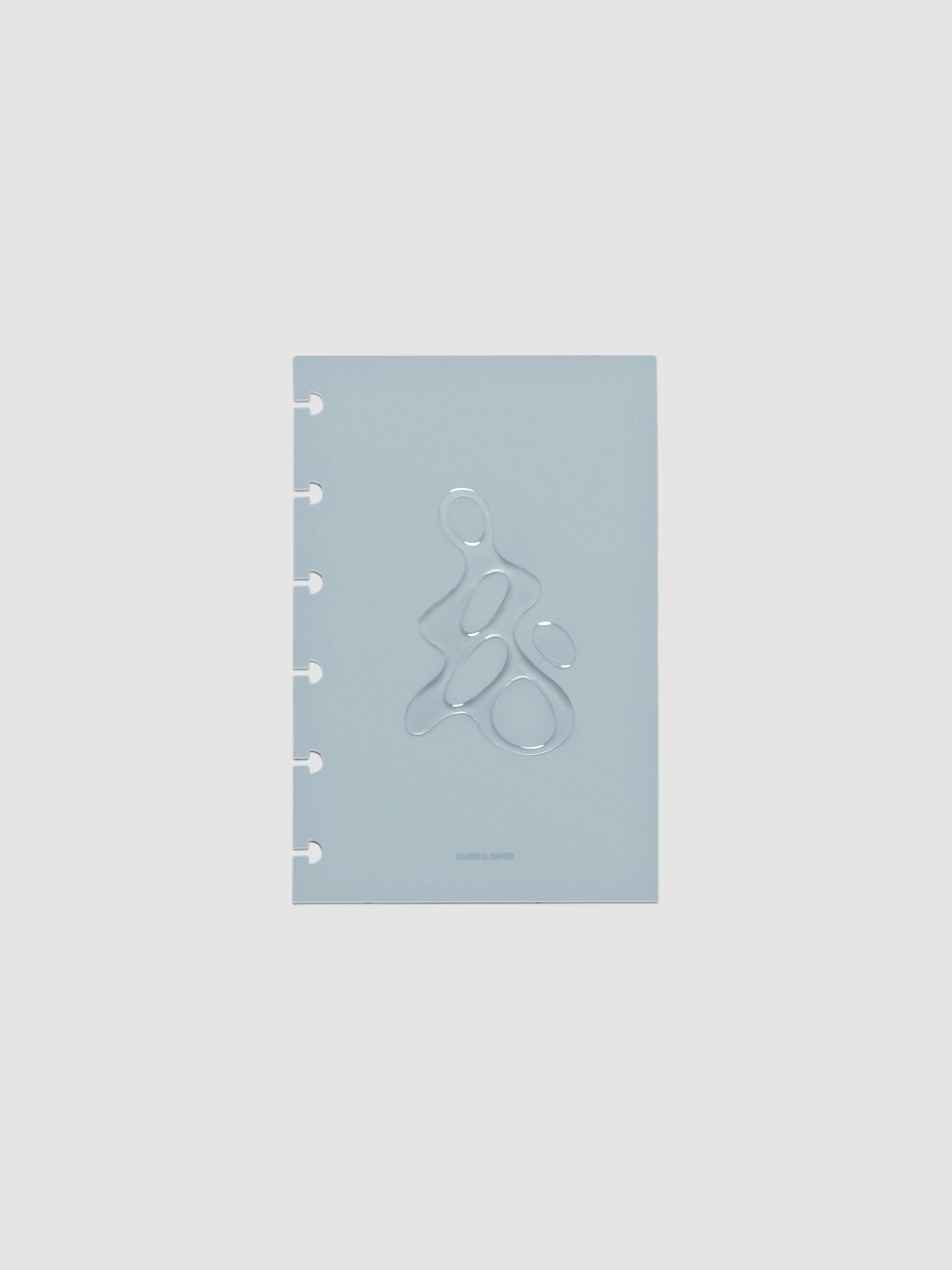 Light blue, semi-transparent, and glossy plastic planner dashboard with organic raised shape design in size CP Petite on a neutral background.