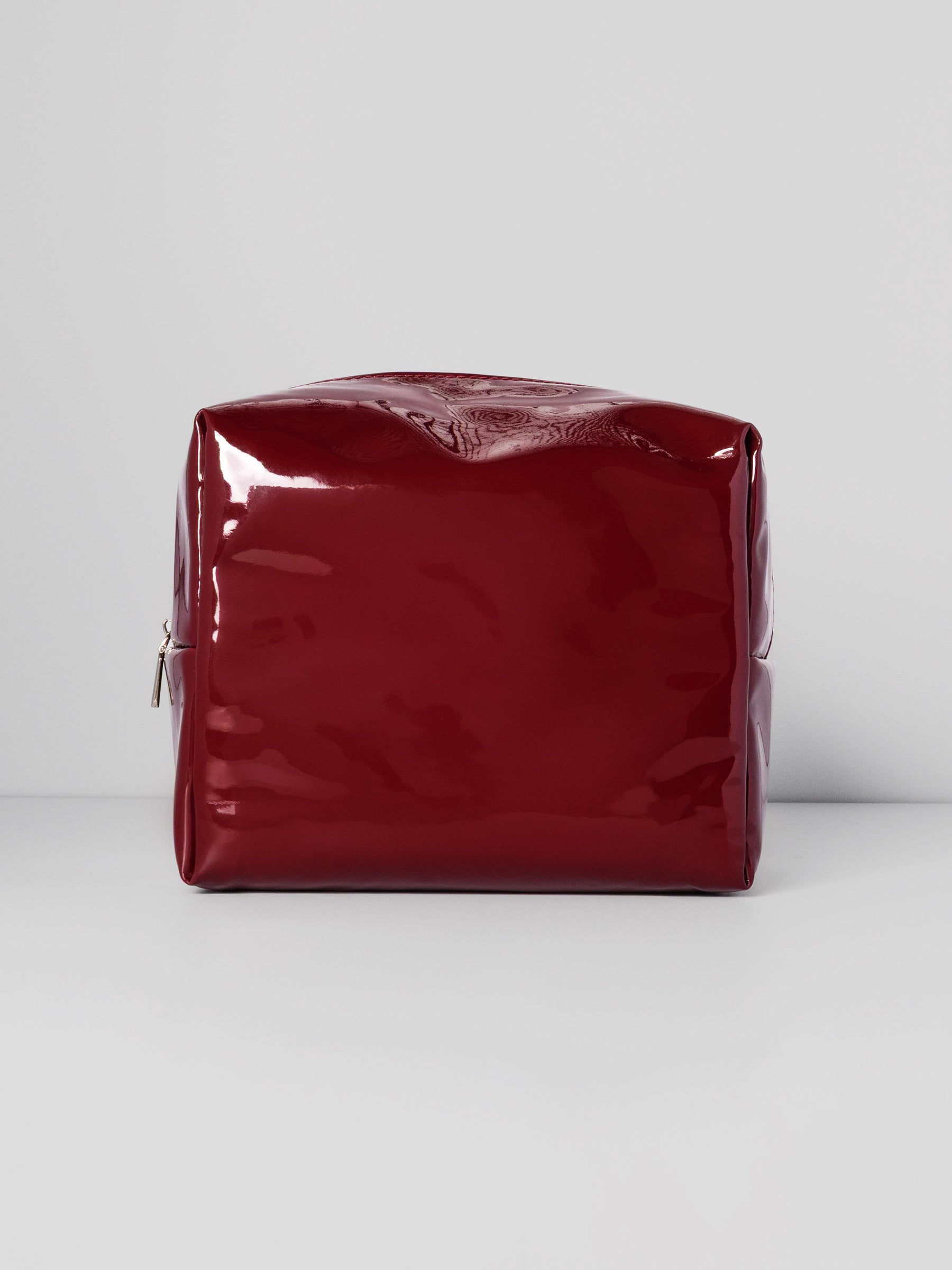 Deep red Lacquered Pouch shown from the front.