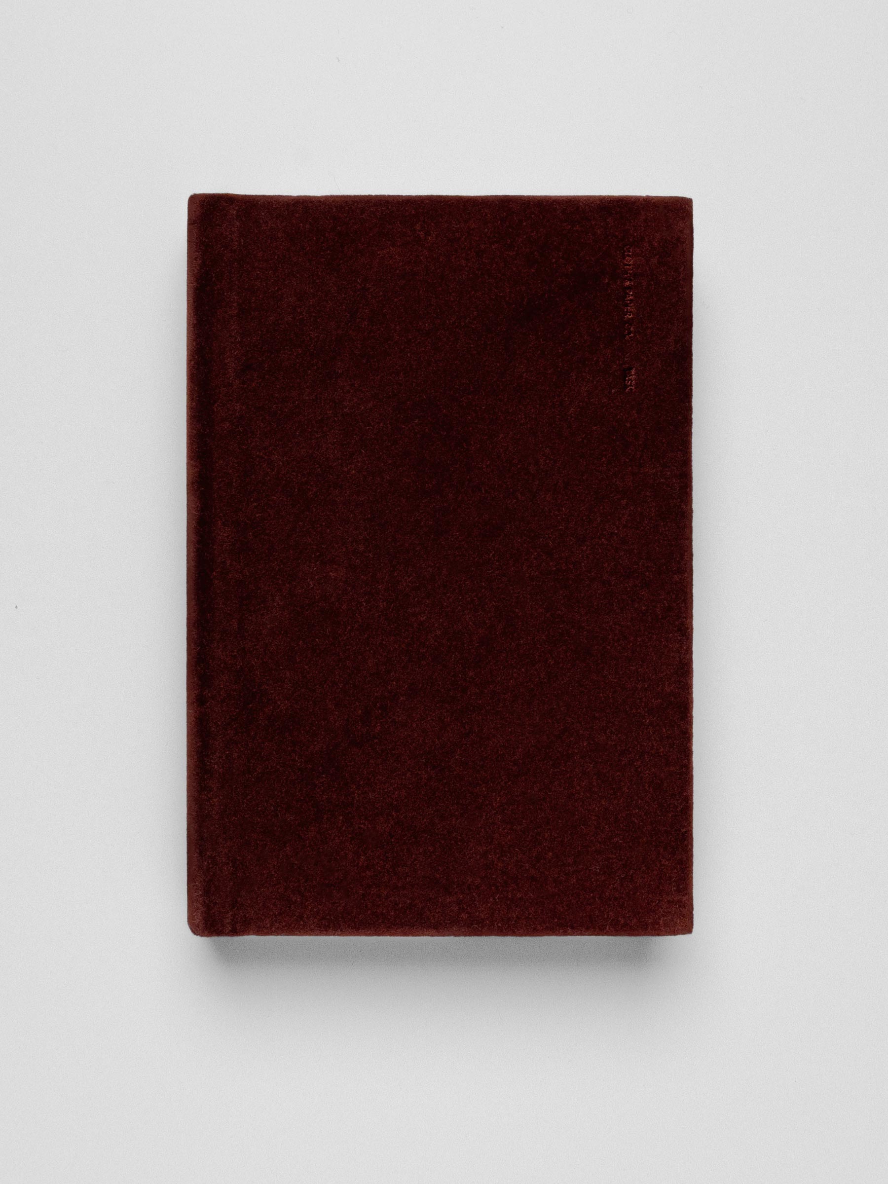 Deep red, velvet CP Petite sizes notebook shown on a neutral background.