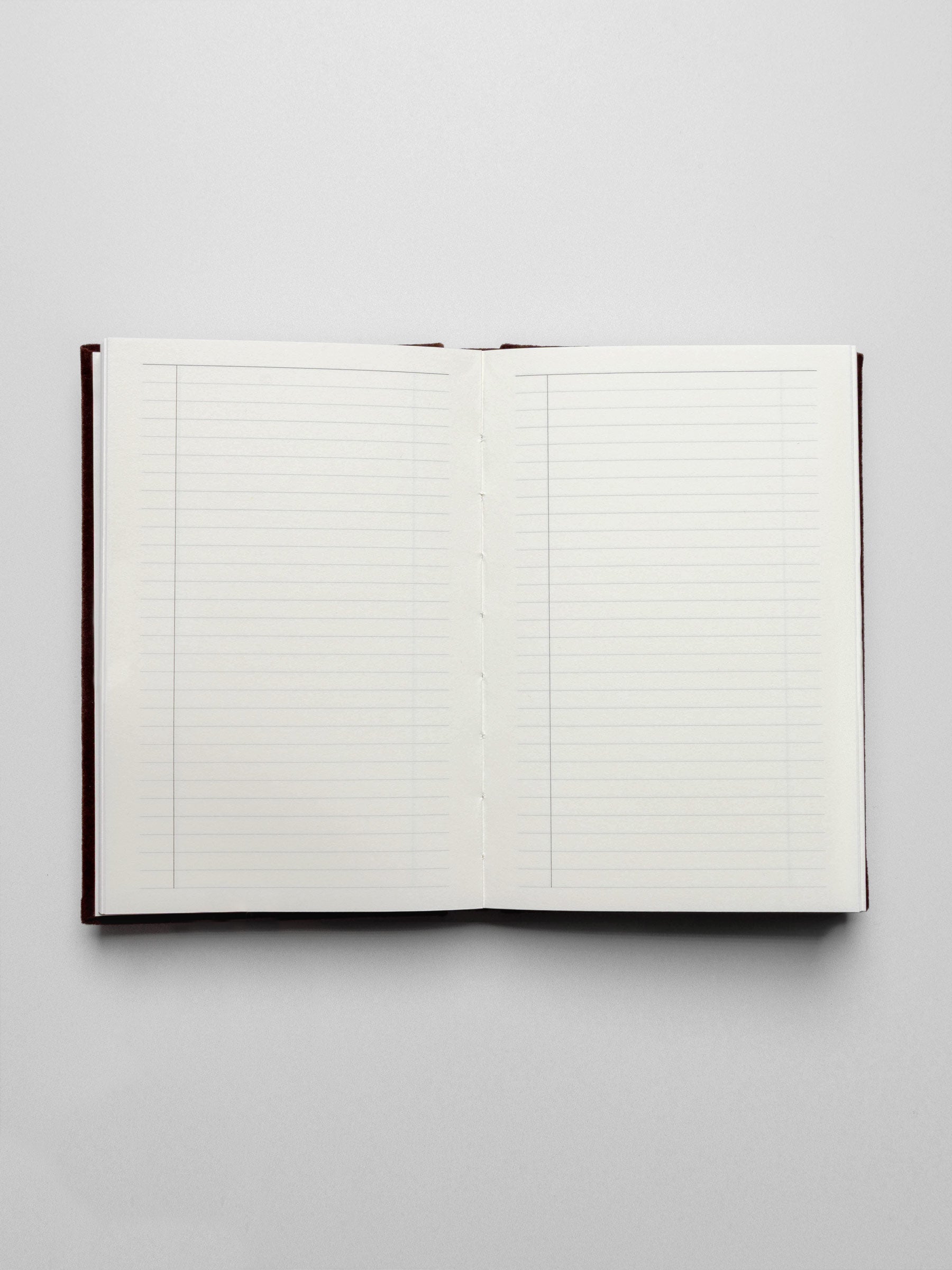 Legends Velvet Notebook shown open, laying flat, displaying task style page layouts.