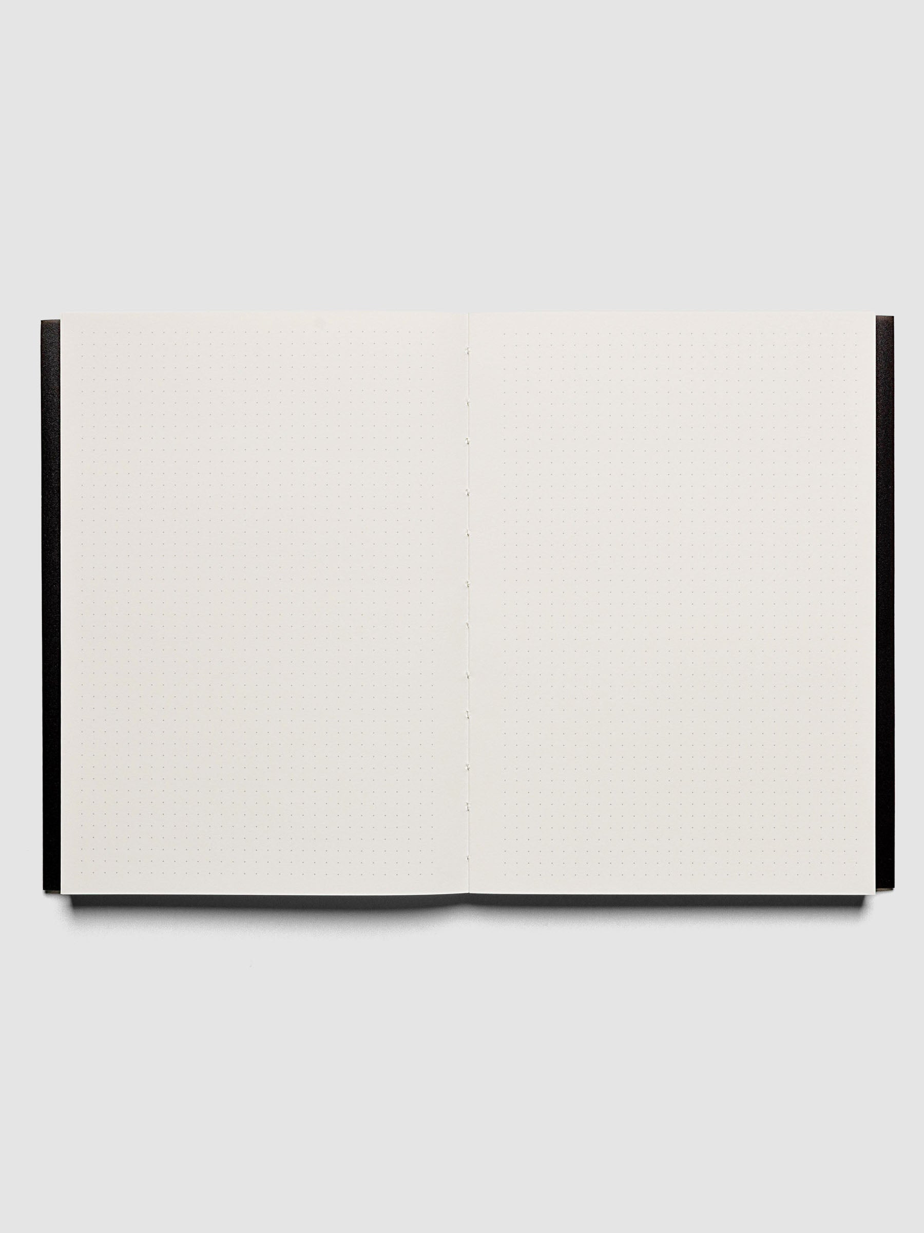 Perfect Bound Notebook | A5 | Dot Grid | Avant Garde shown open, laying flat, displaying the dot grid layout.