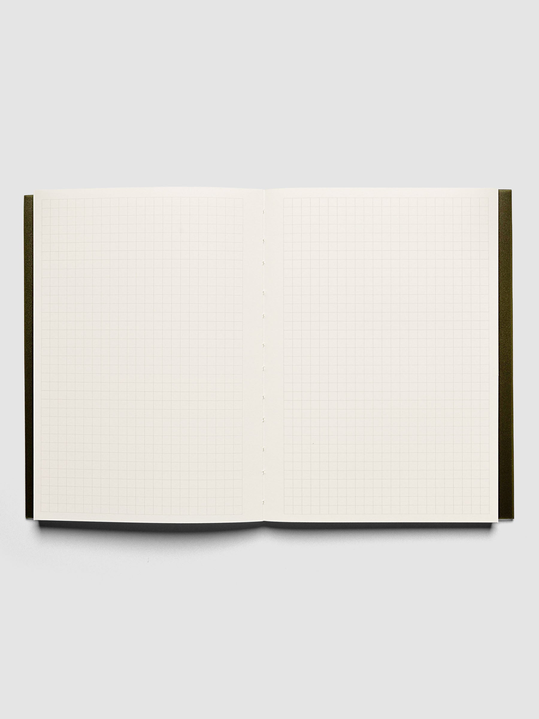 Perfect Bound Notebook | A5 | Graph | Olive shown open, laid flat on a neutral background. Pages have graph note layouts.