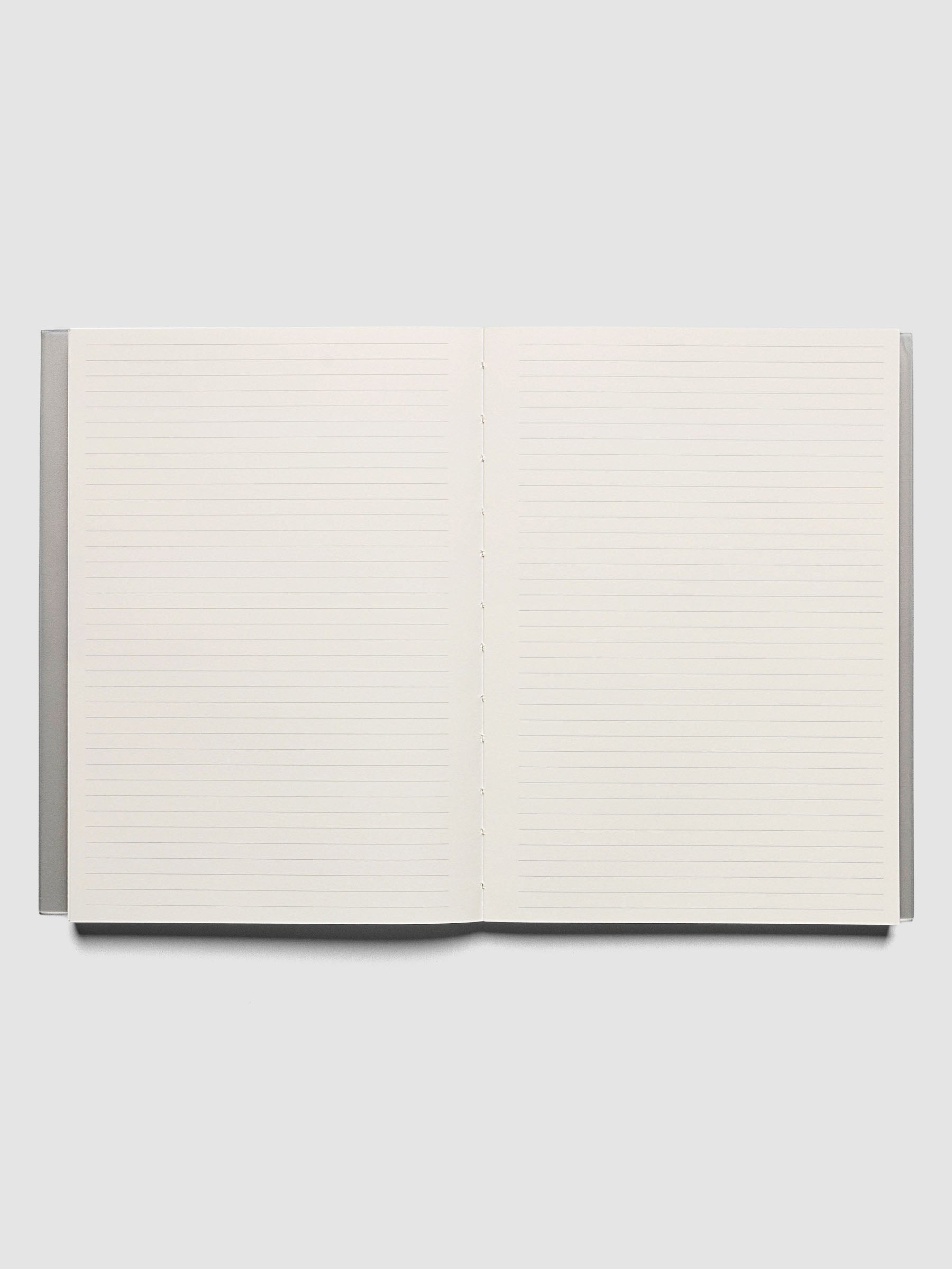 Perfect Bound Notebook | A5 | Lined | Ash shown open, laid flat, on a neutral background. Both pages have a lined notes layout.