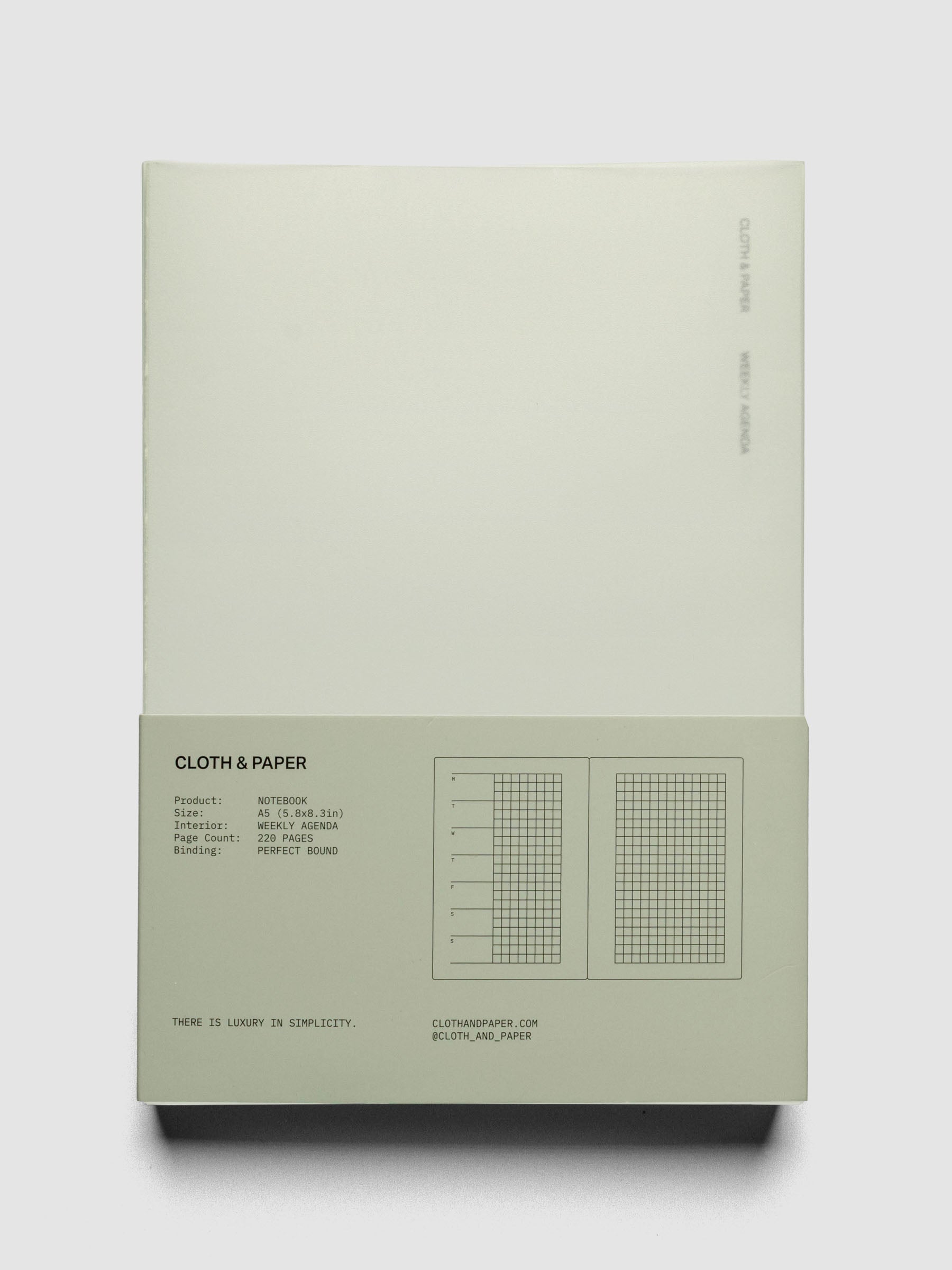Perfect Bound Notebook | A5 | Weekly Agenda | Matcha shown closed, laying flat, in packaging on a neutral background.