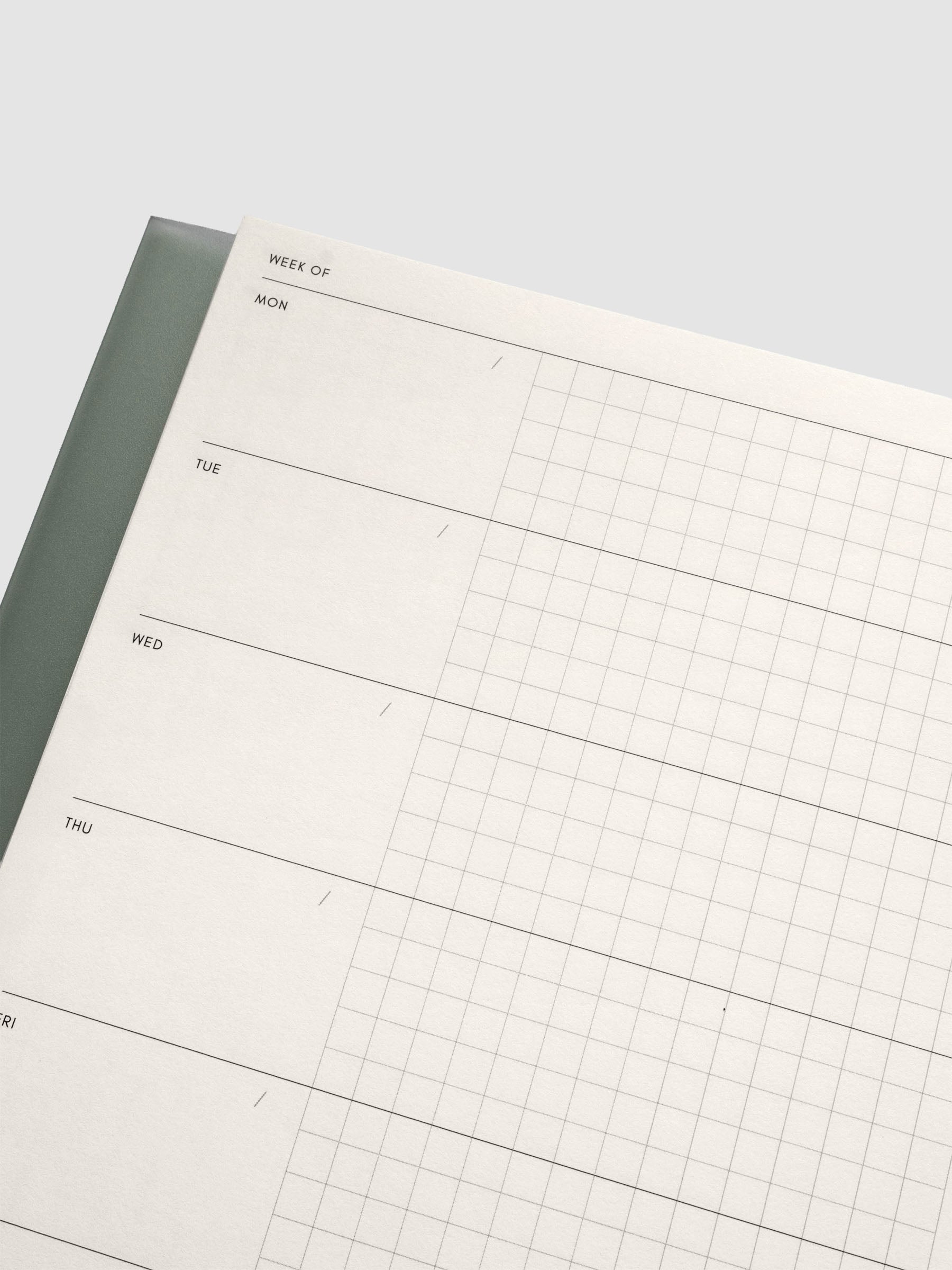 Close up of the Perfect Bound Notebook | A5 | Weekly Agenda | Matcha showing the horizontal weekly layout with blank space for notes, the date, and a graph notes section.