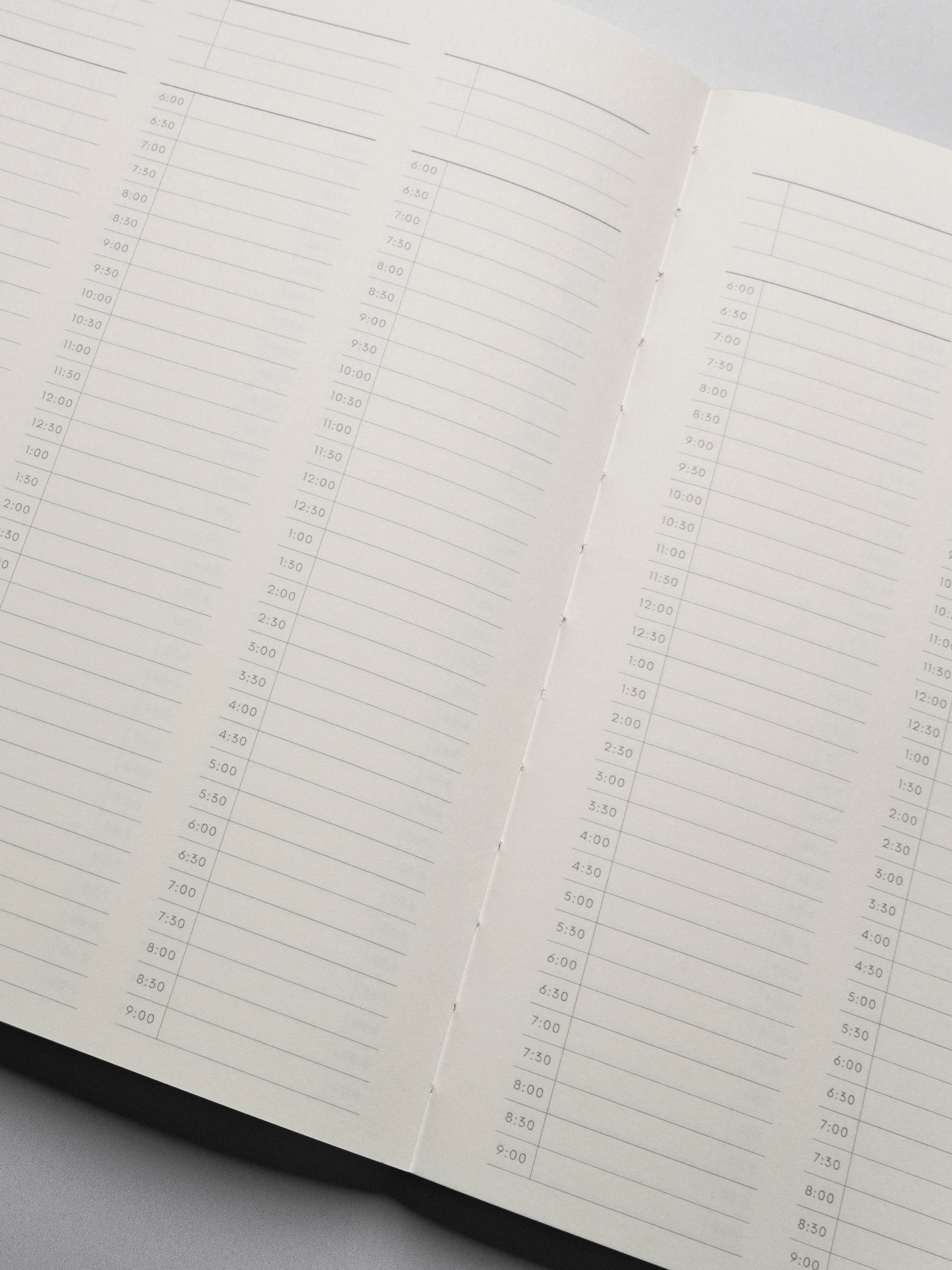 Perfect Bound Notebook in size HP Classic with 30 Minute Time Block pages shown close up showing the lay flat capabilities.