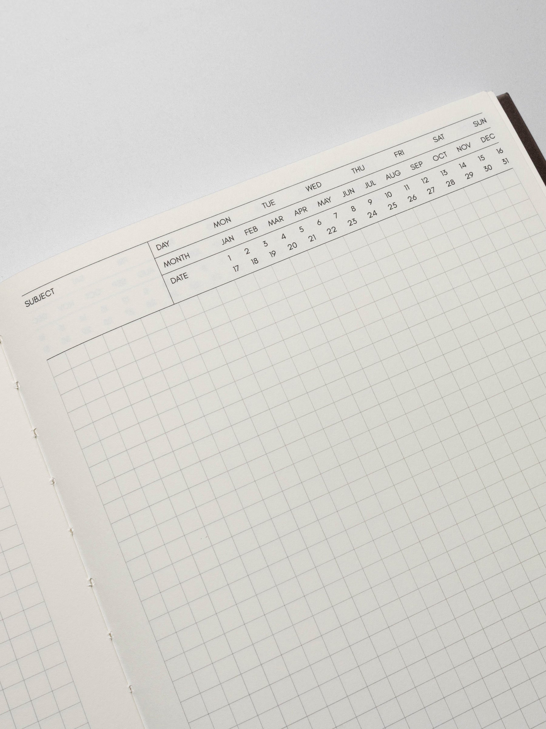 Perfect Bound Notebook in size HP Classic with Executive Notes pages shown close up to display the fields to write subject and mark day, month, and date with open grid note space for note taking below.