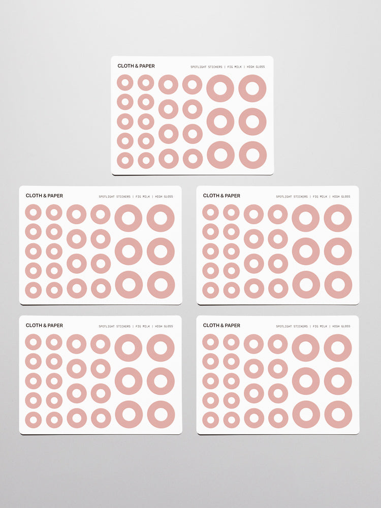 Five sticker sheets of pink (fig milk) Spotlight Stickers | High Gloss on a neutral background.