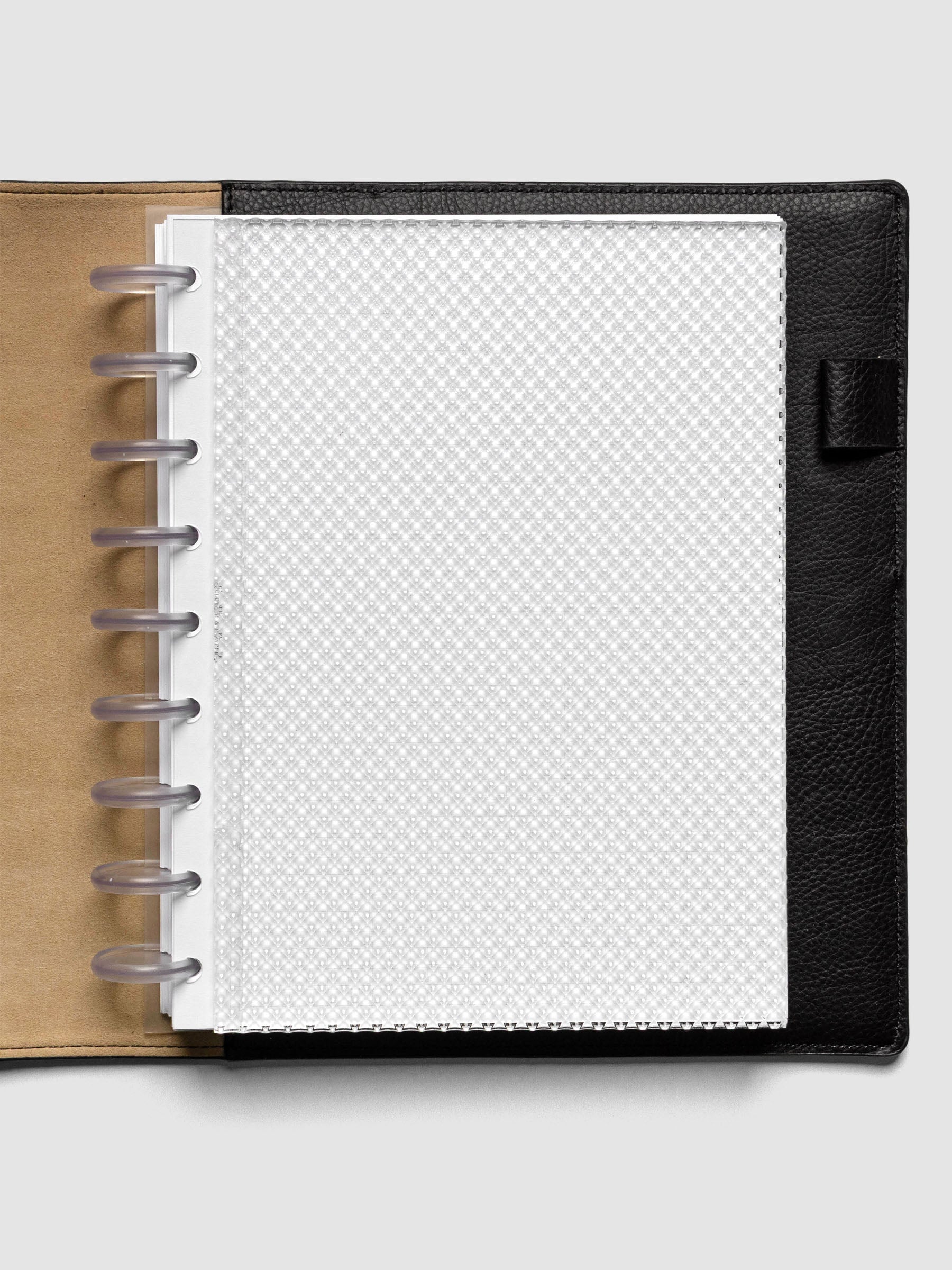 Clear, textured Studded Planner Dashboard in the size HP Classic, shown discbound in a black leather folio on a neutral background.