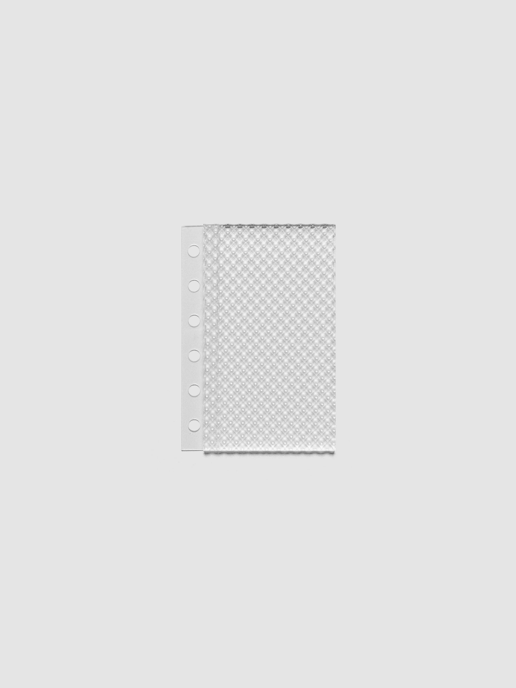 Clear, textured Studded Planner Dashboard in the size Pocket, on a neutral background.