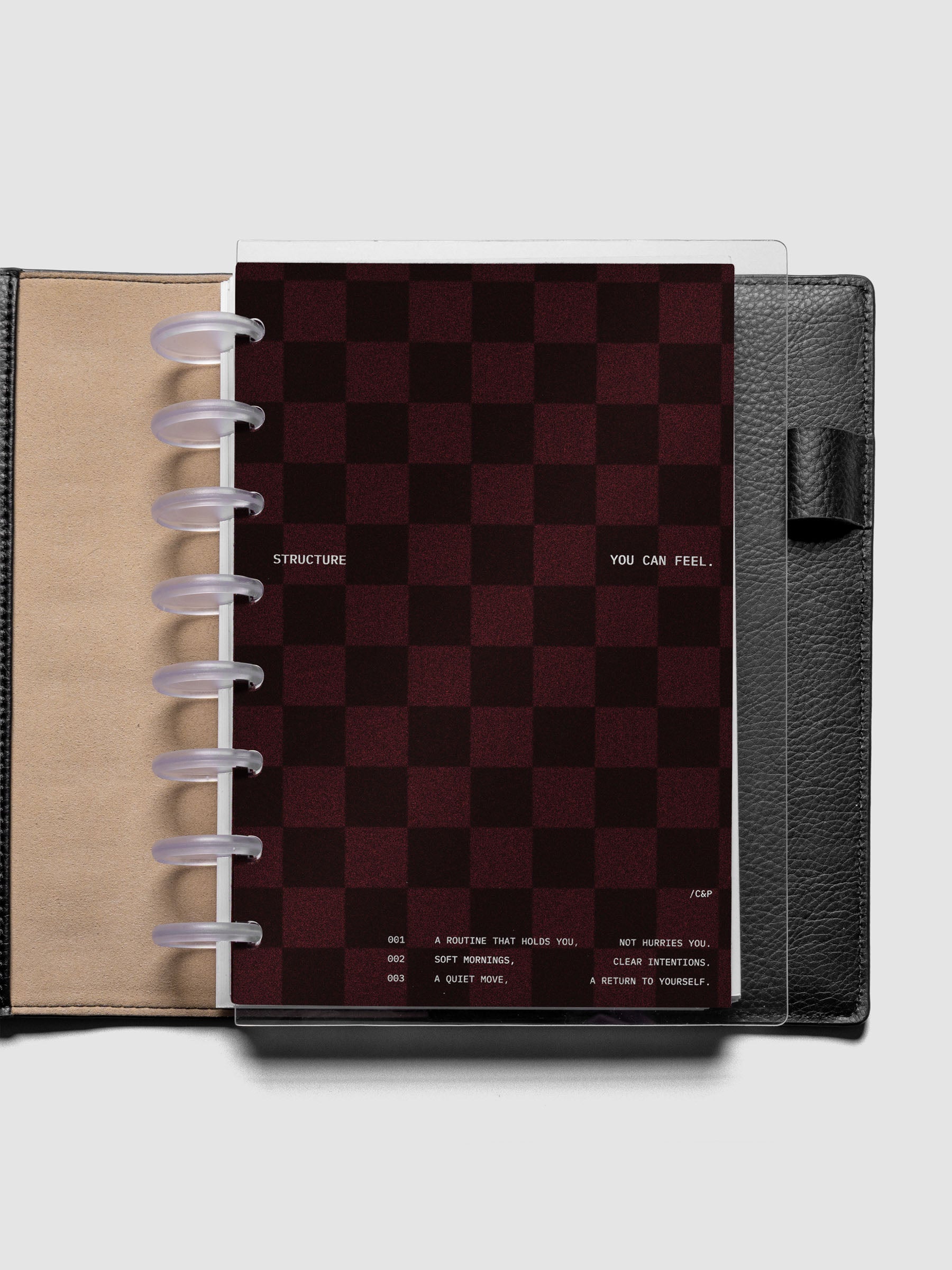 Half Letter sized velvet checkered dashboard in the color Bordeaux with crystal clear planner dashboard shown inside a black leather folio.