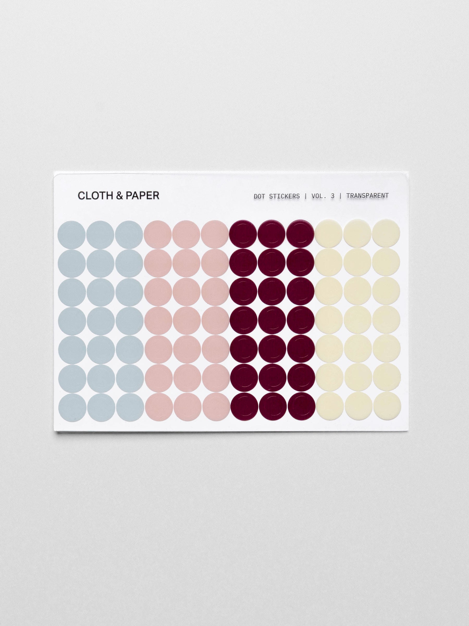 One sheet of transparent small dot stickers in four colors including light blue, light pink, burgundy, and light yellow shown against a neutral background.