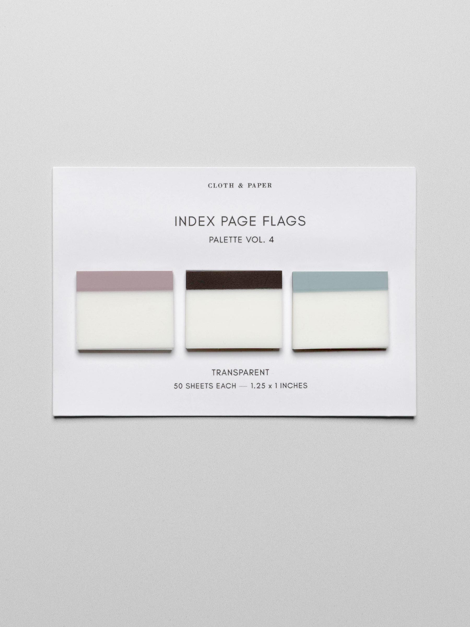 Set of three unique colors of transparent index page flags including pink, brown, and blue shown laying flat on backing card against a neutral background.