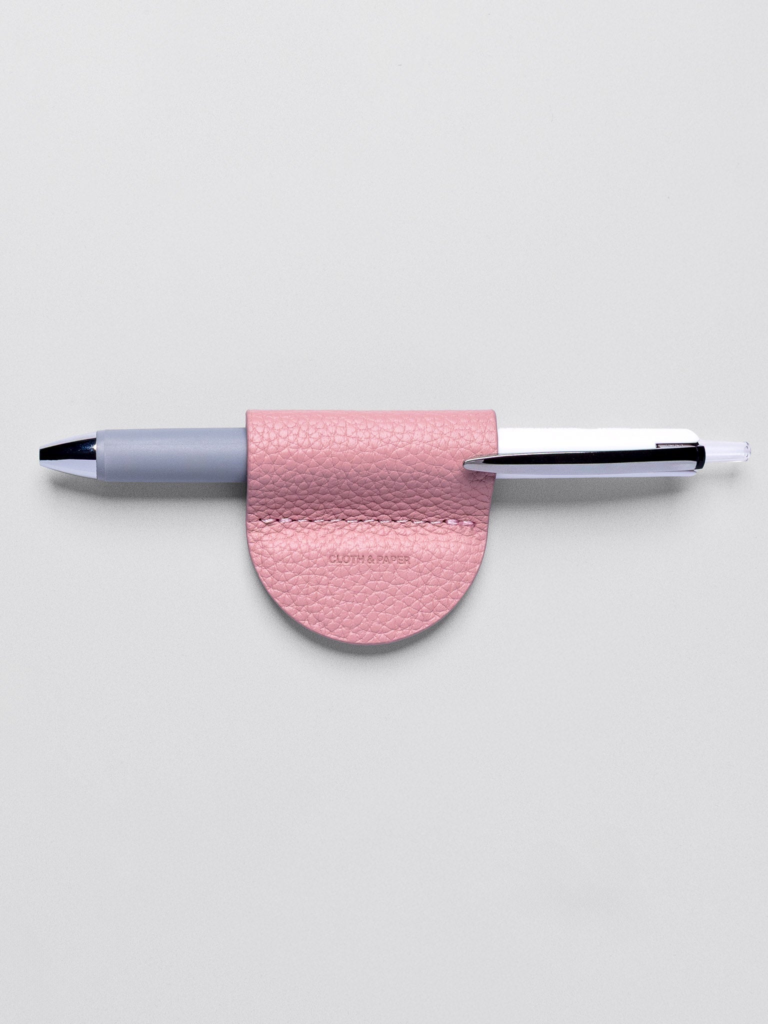 Magnetic Bookmark | Pen Holder in color Fig Milk (light pink) with pen in pen loop.