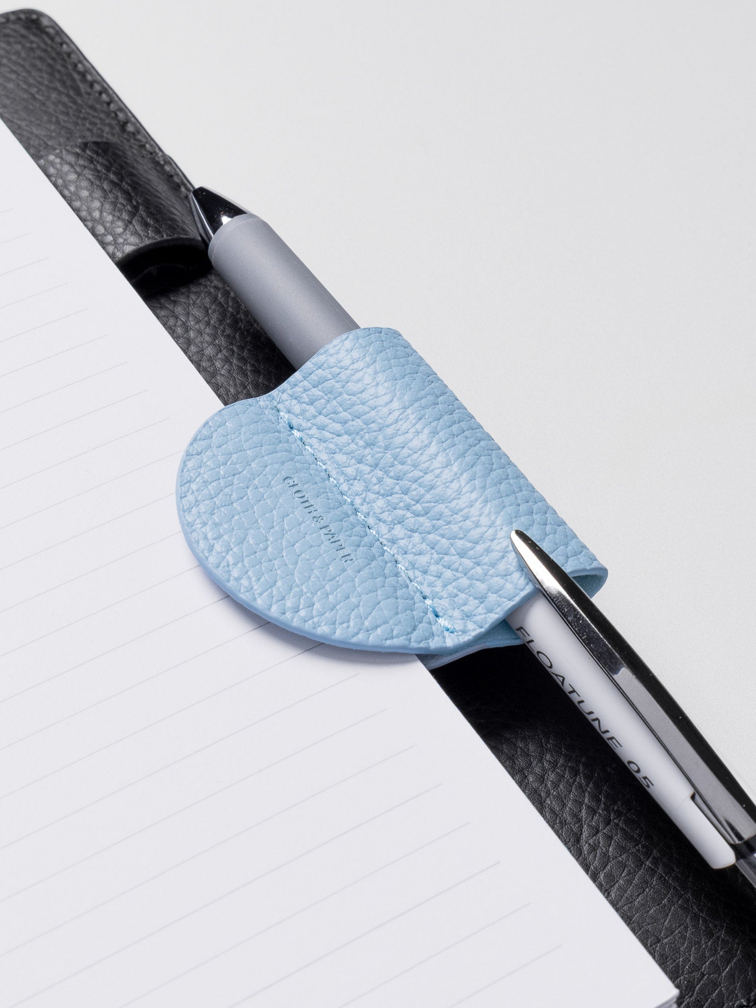 Magnetic Bookmark | Pen Holder in color Smoked Salt (light blue) with pen in pen loop.