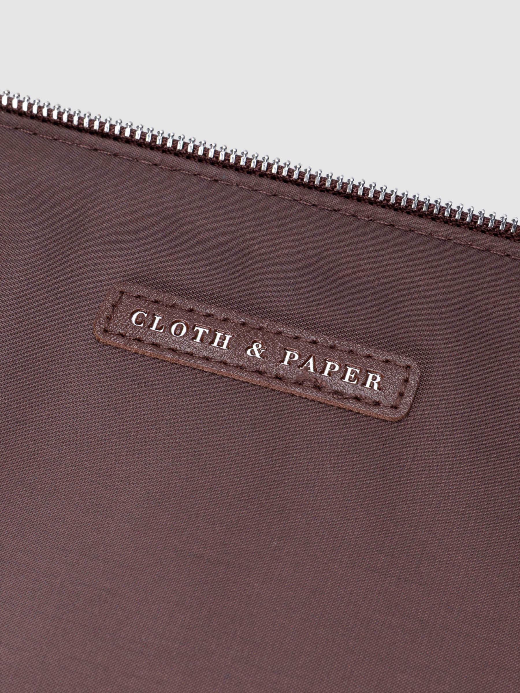 Close up image of the interior leather tag reading CLOTH & PAPER.