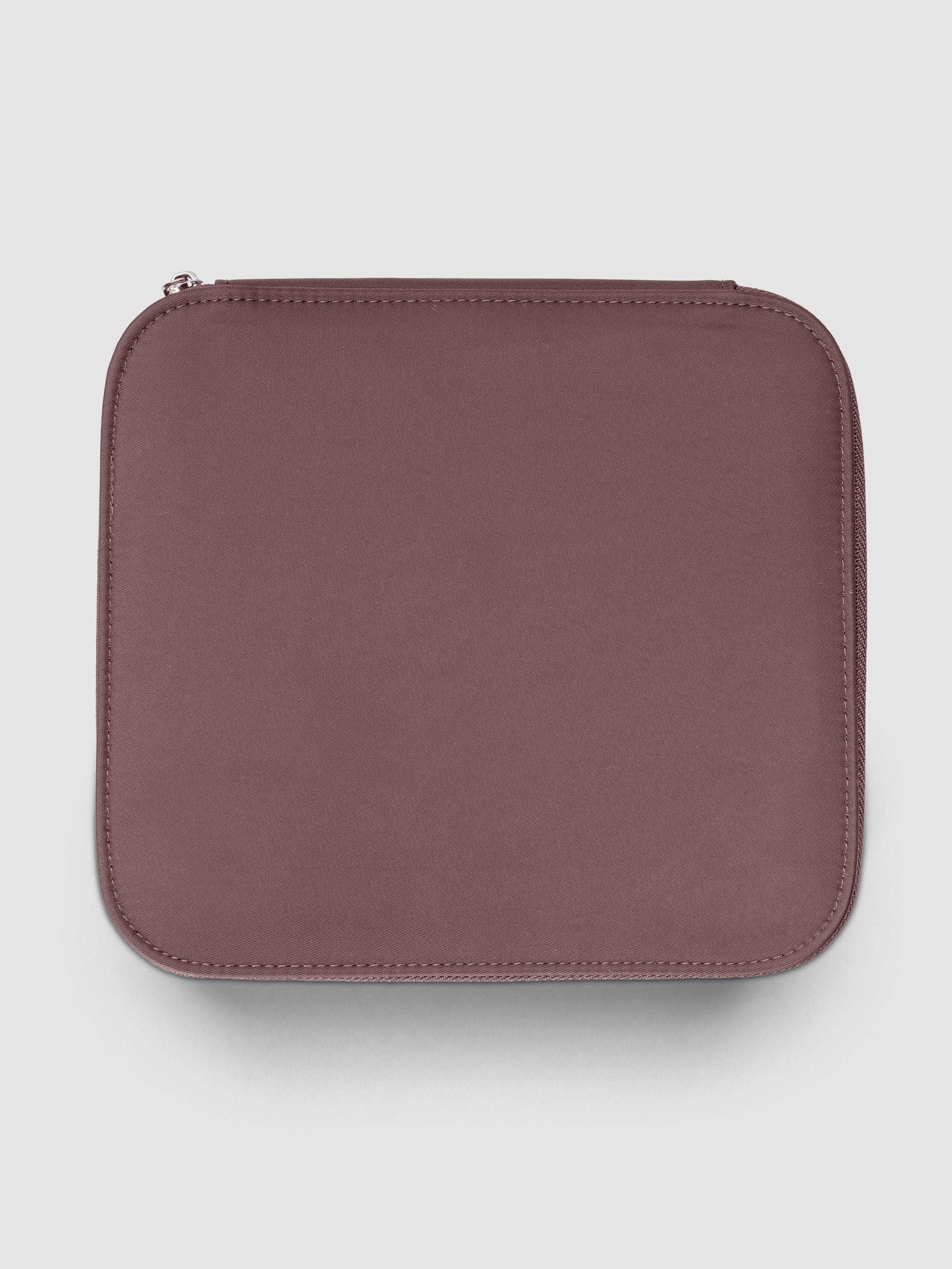 Medium packing cube in the color walnut against a neutral background.