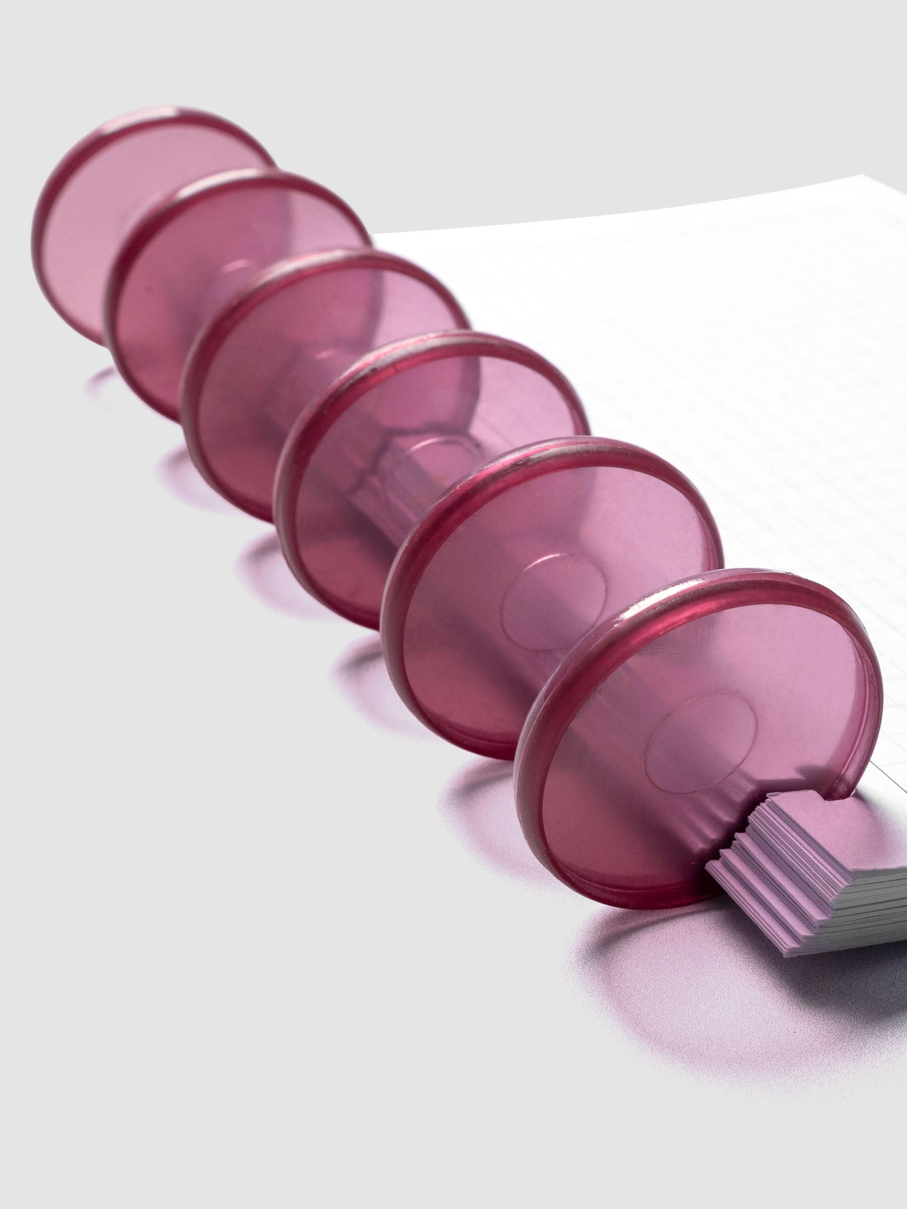 Planner Inserts in size CP Petite fitted onto Transparent Planner Discs | Bordeaux in size 1.25 in shown at an angle.