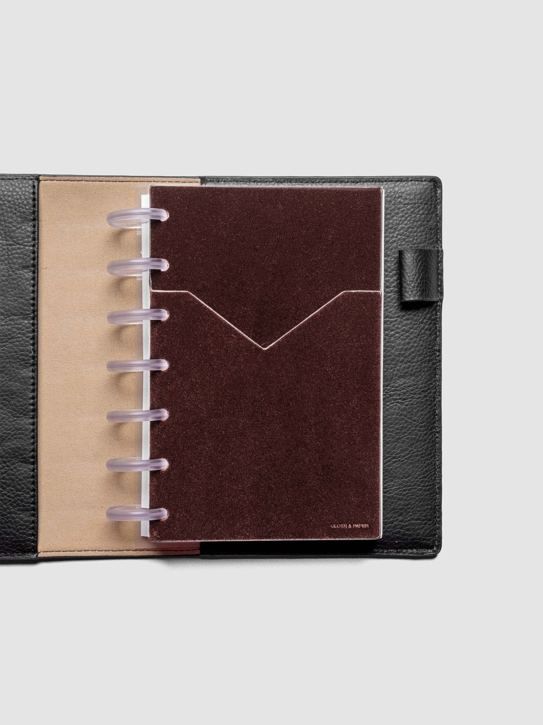 Velvet Pocket Folder in Bordeaux pre-punched for HP Mini planners shown in a black leather folio.